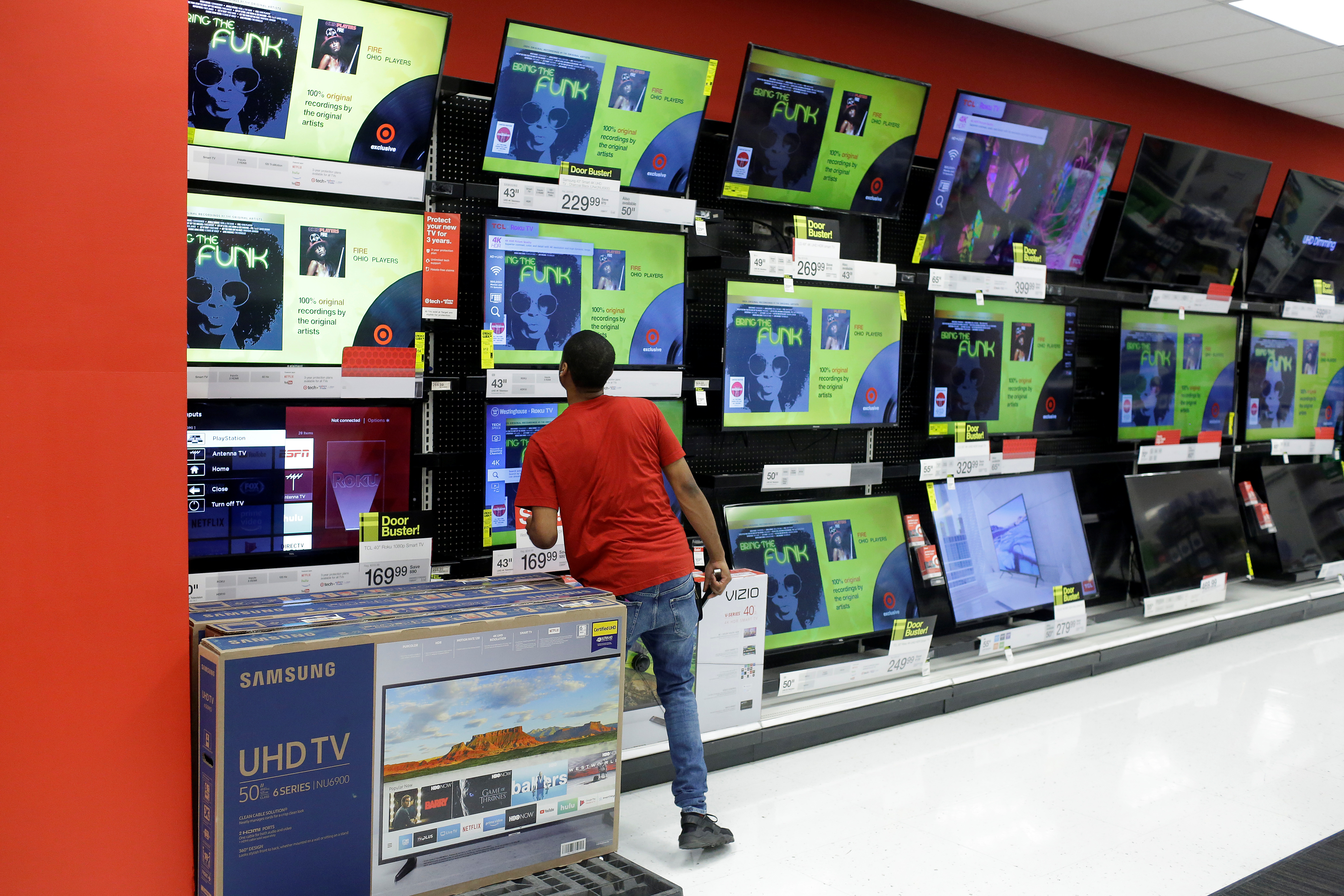 A worker looks at a television during Black Friday sales at a Target store in Chicago