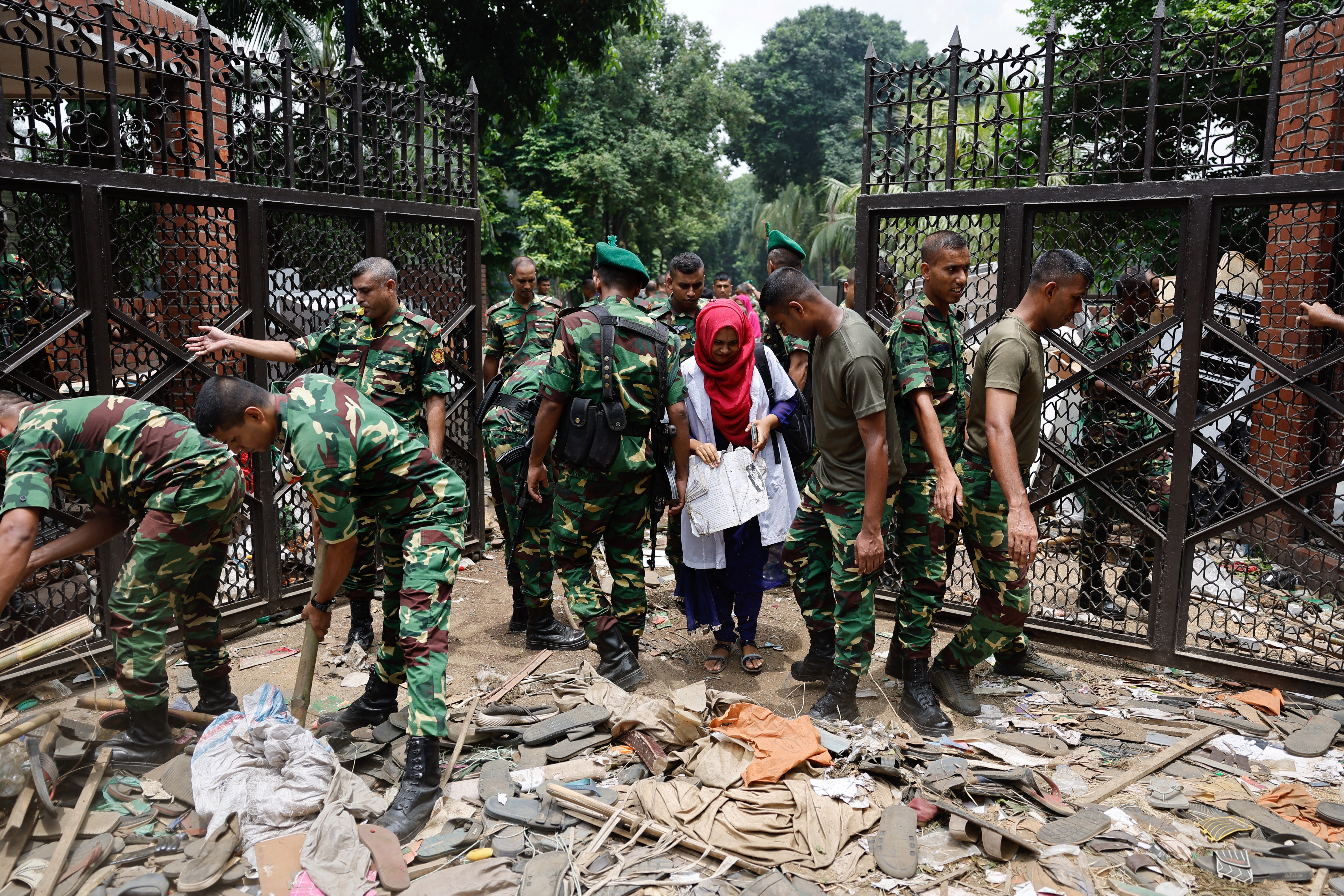 Army members clear an entrance of the Ganabhaban after Bangladeshi PM Hasina's resignation, in Dhaka