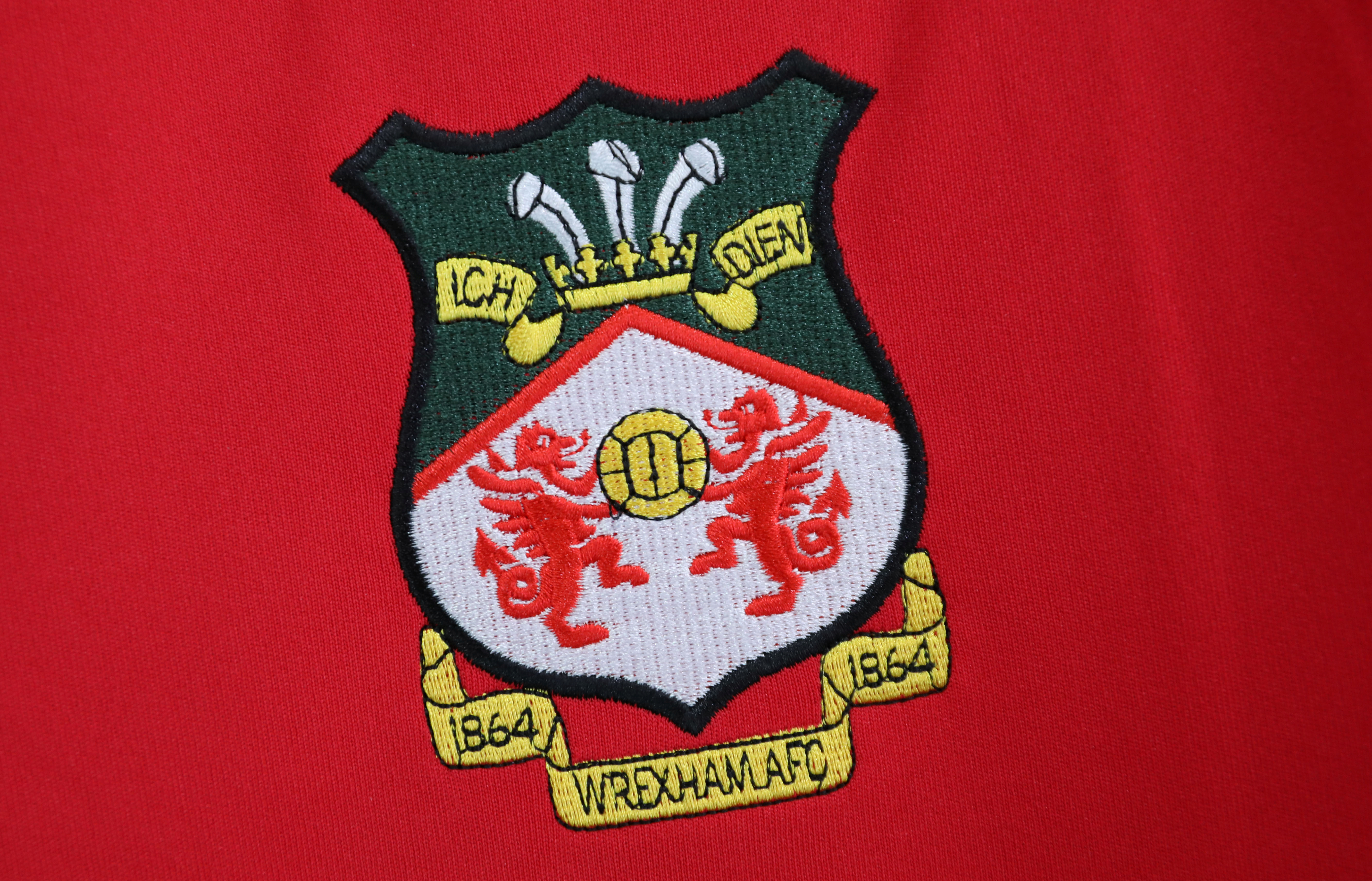 The club badge is pictured on a team shirt in the club shop at Wrexham Football Club in Wrexham, Britain