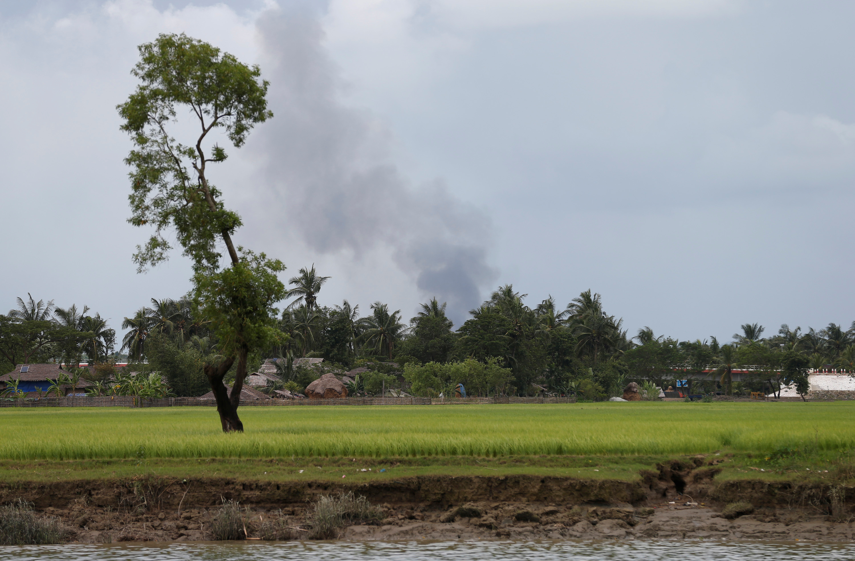 Fire smokes are seen over a village in Buthidaung