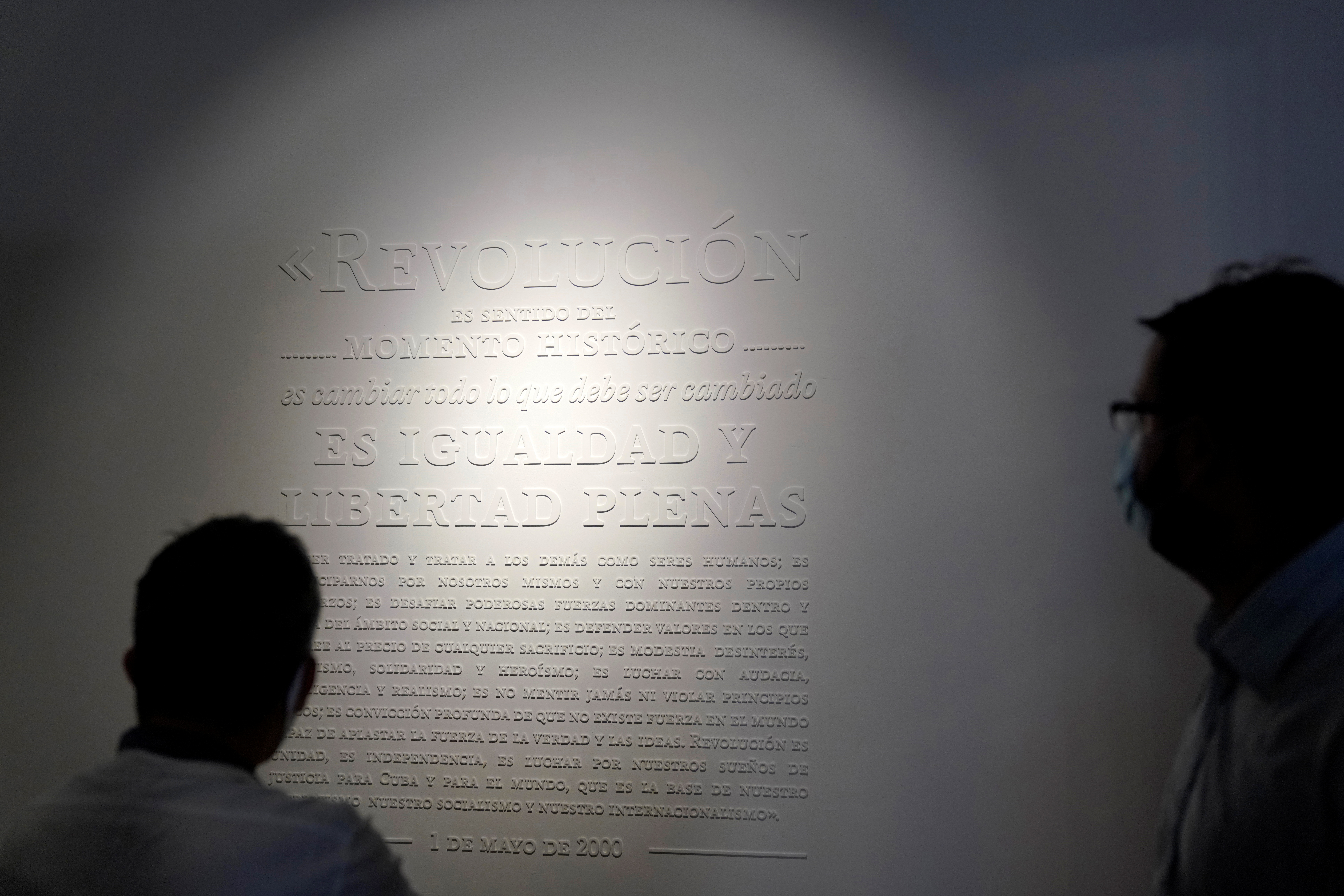 People read a quote on revolution by Cuba's late leader Fidel Castro at the museum 
