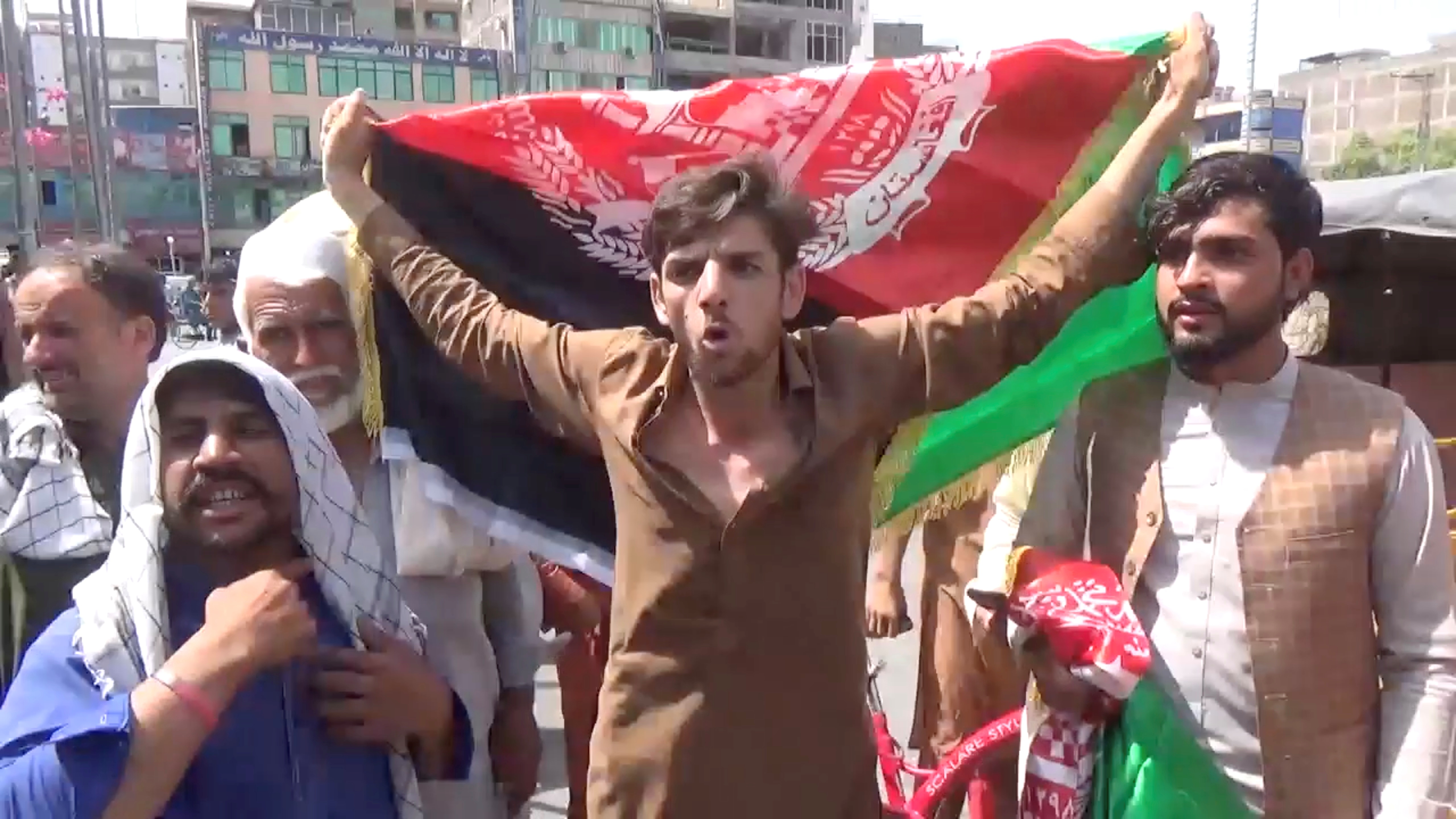 People carry Afghan flags as they take part in an anti-Taliban protest in Jalalabad, Afghanistan August 18, 2021 in this screen grab taken from a video. Pajhwok Afghan News/Handout via REUTERS