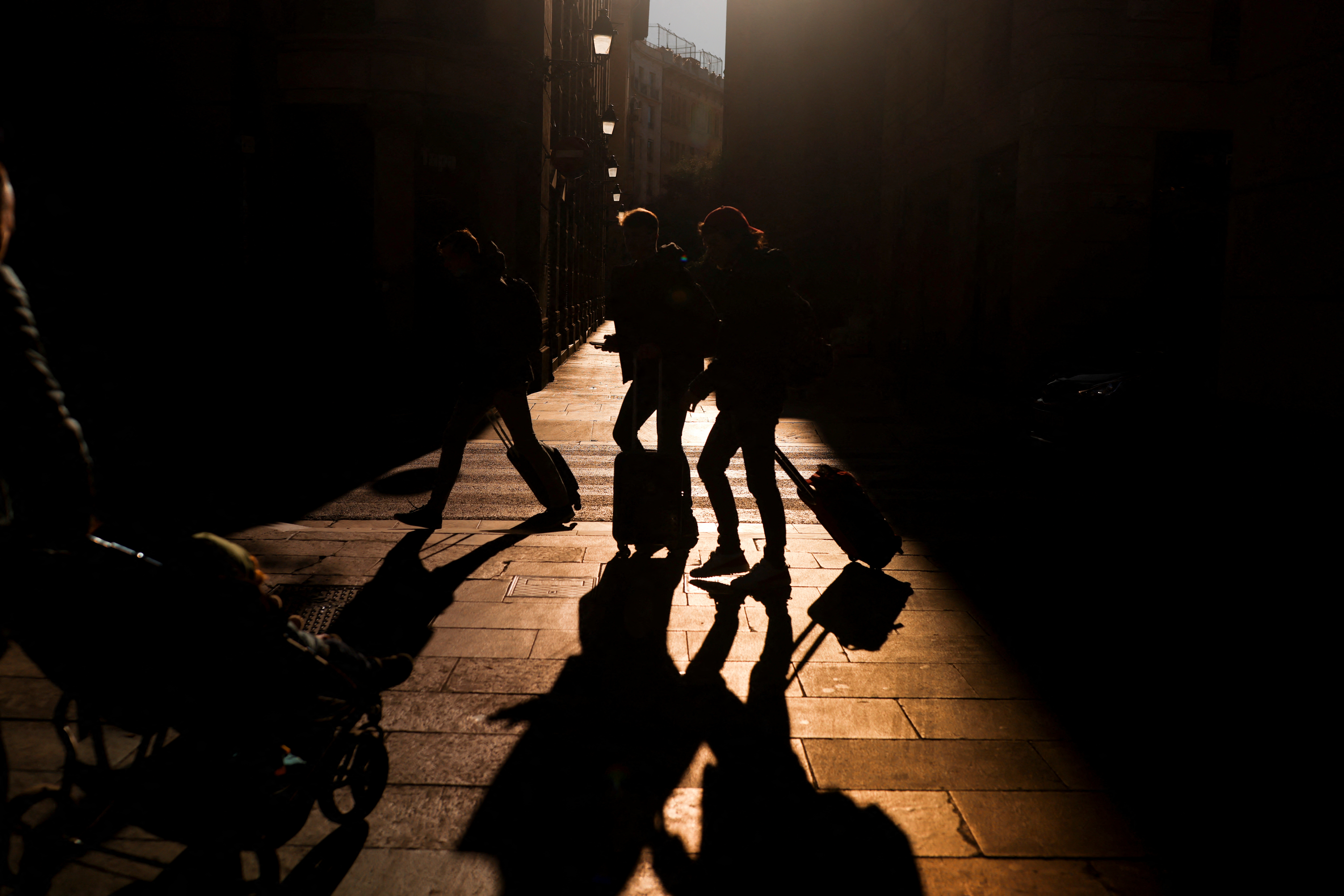 Tourists enjoy in the winter sun in Barcelona
