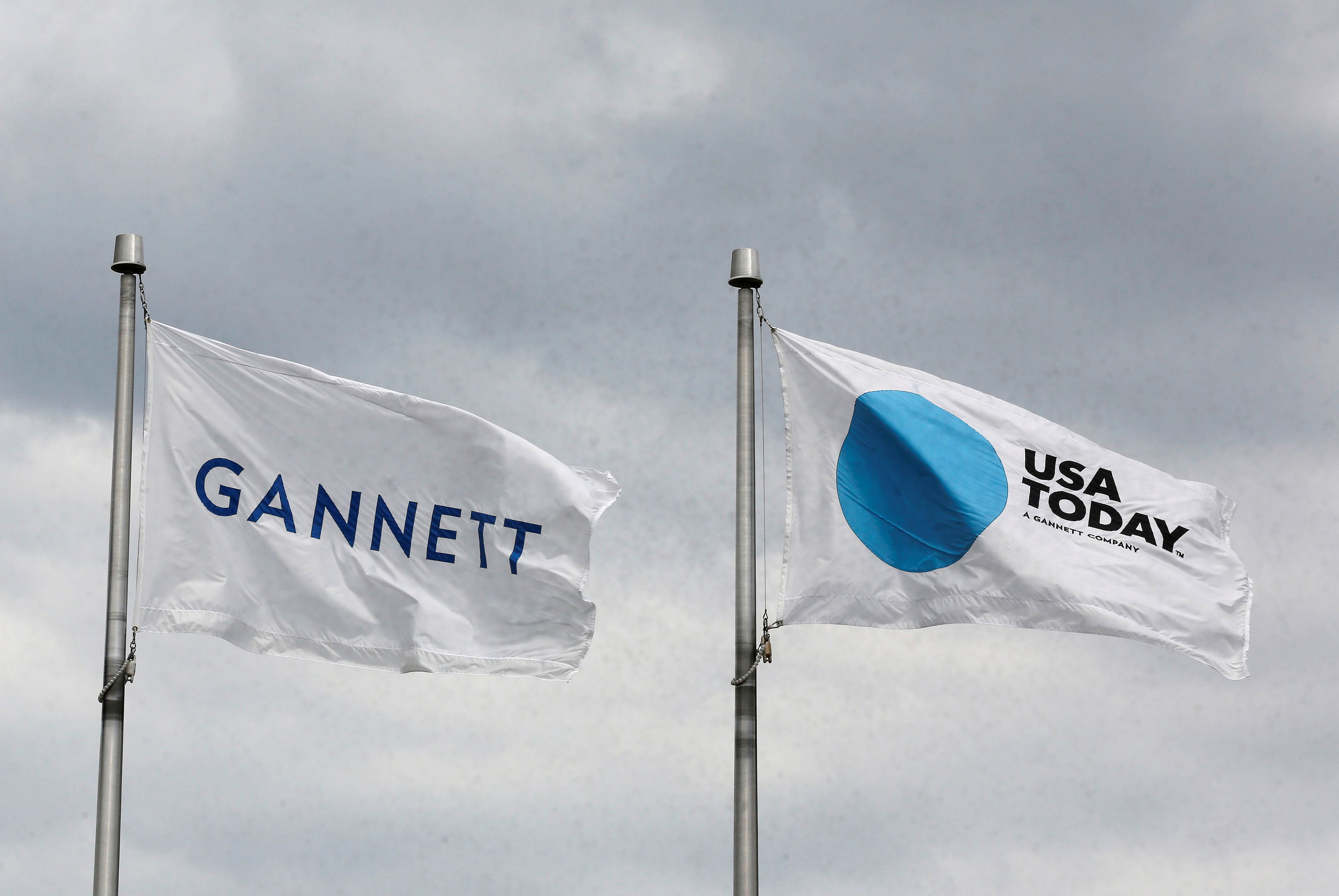 The corporate flags for the Gannett Co and its flagship newspaper, USA Today, outside headquarters in McLean, Virginia