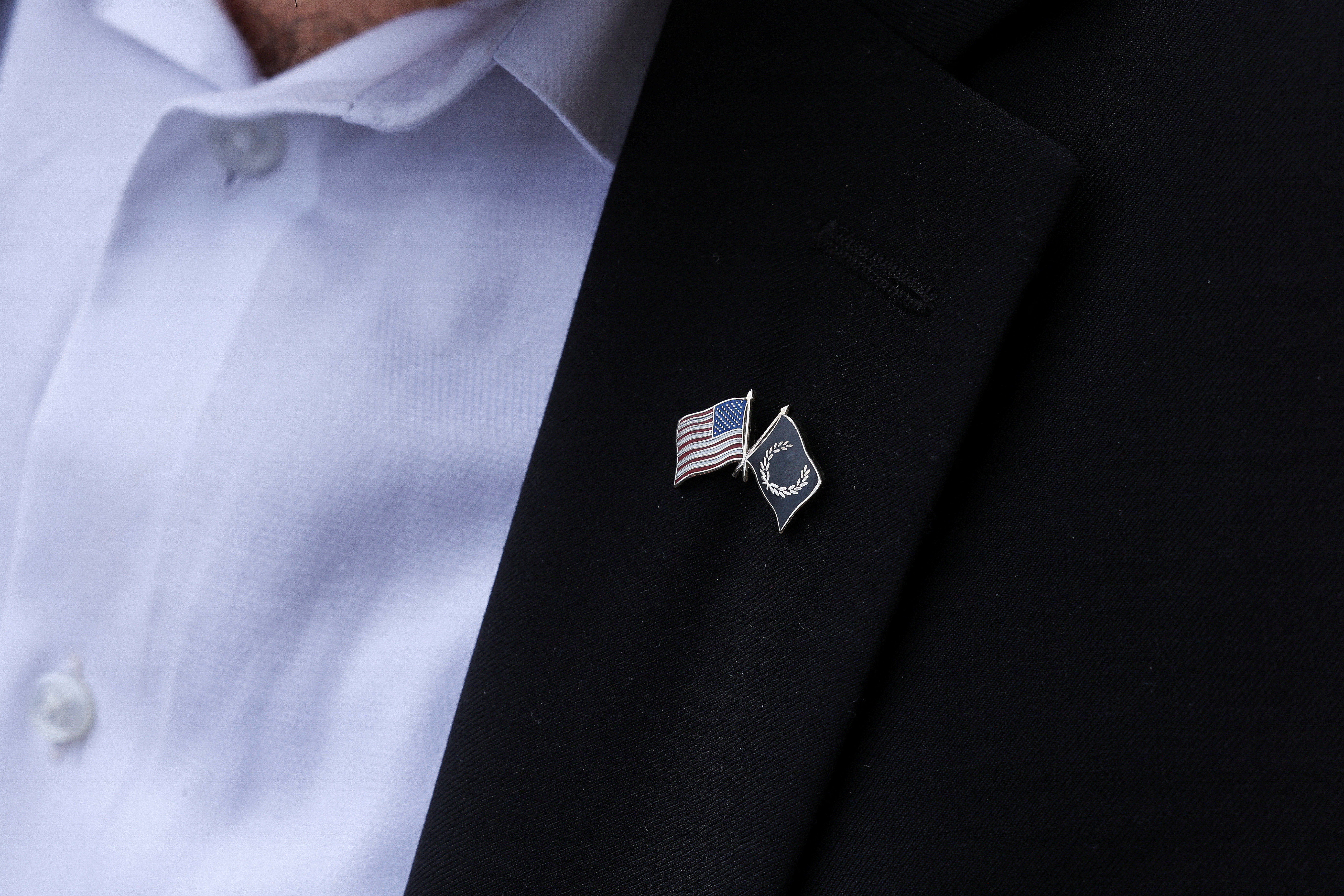 A Proud Boys lapel is seen on a member of the organization as he stands outside of the U.S. Federal Courthouse in Washington, D.C.