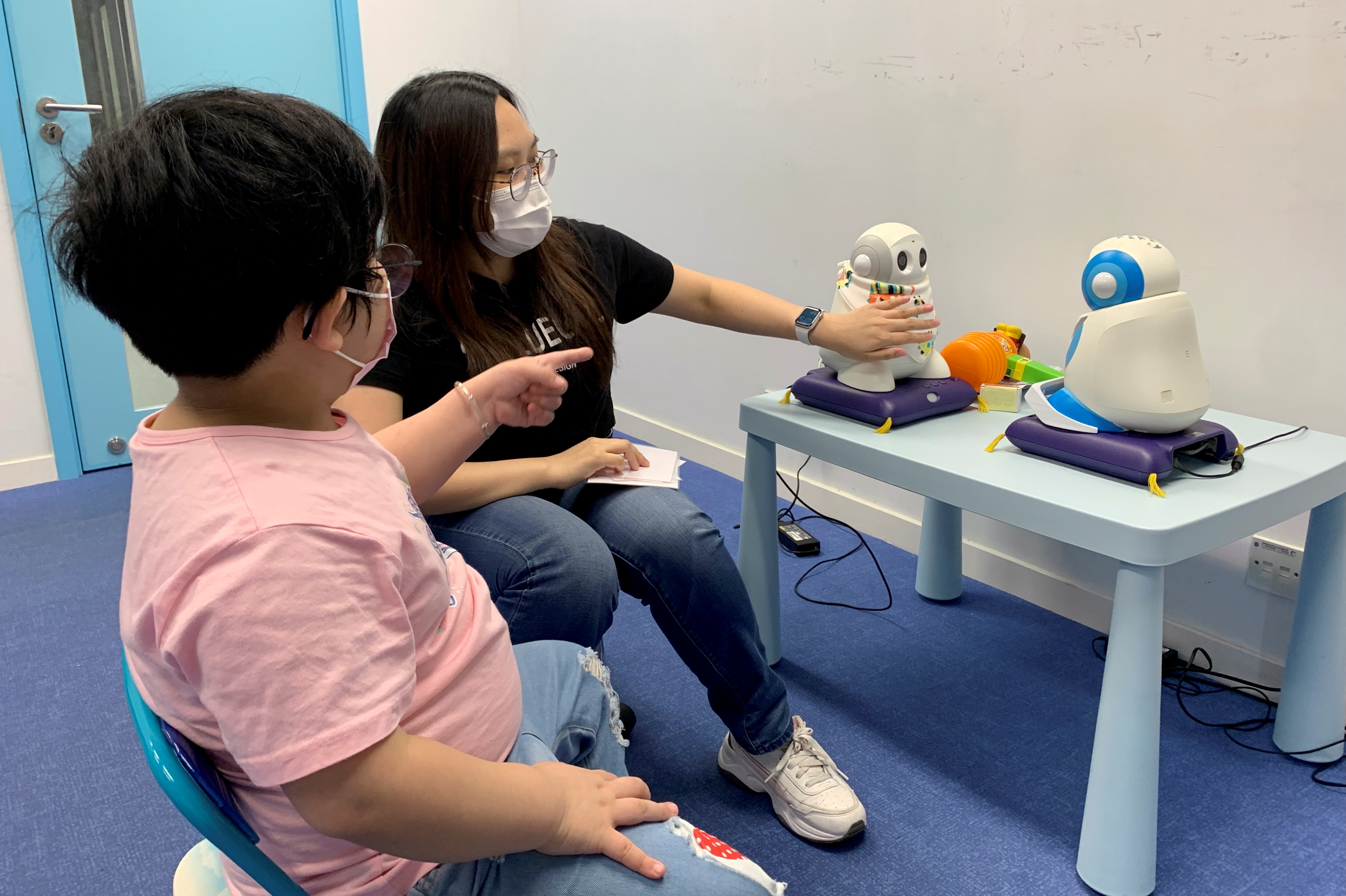 Autism tutor Sarah Ng uses robots to teach a 5-year-old child in Hong Kong