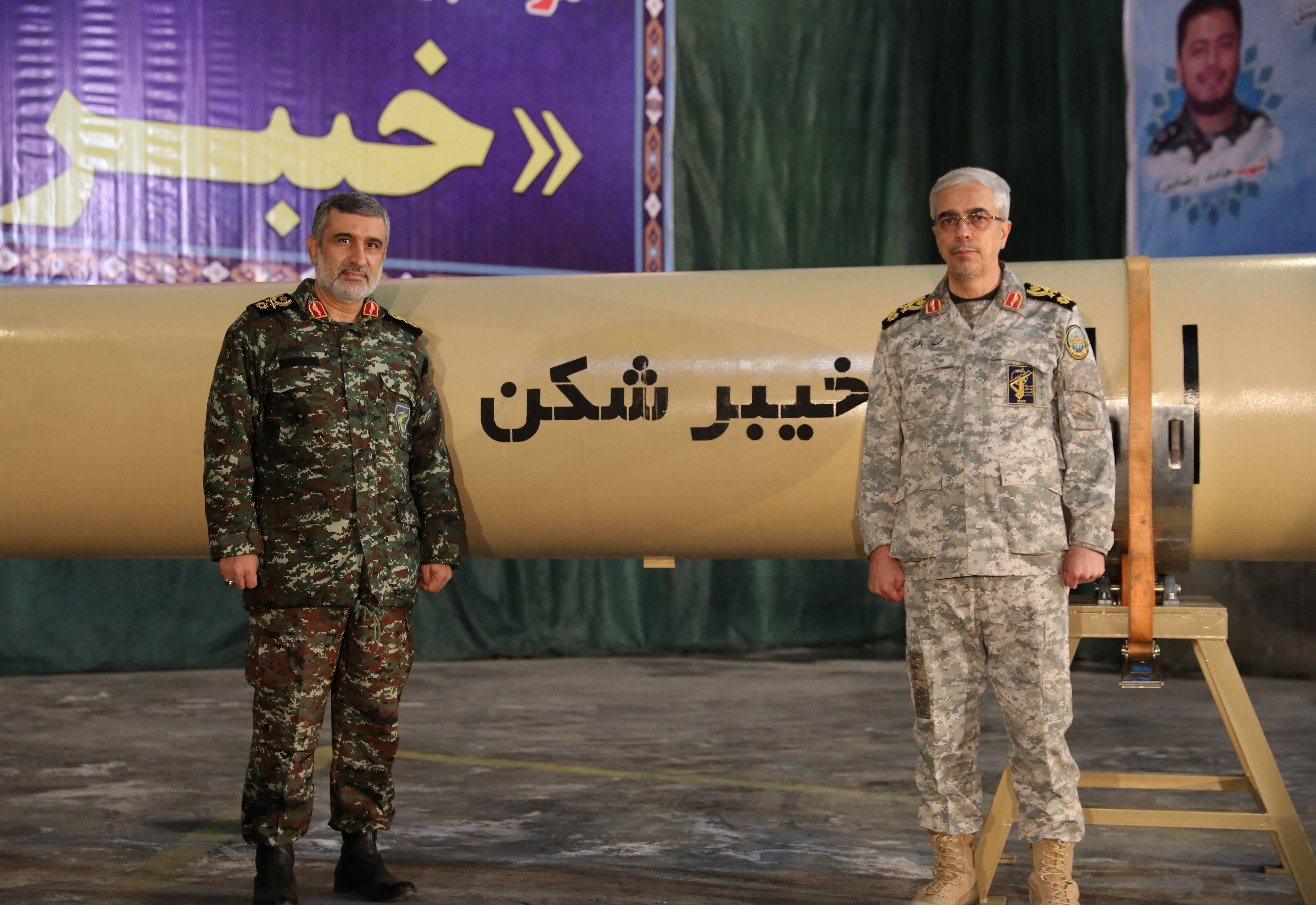 Iranian Armed Forces Chief of Staff Major General Mohammad Bagheri and IRGC Aerospace Force Commander Amir Ali Hajizadeh stand together during the unveiling of "Kheibarshekan" missile at an undisclosed location in Iran