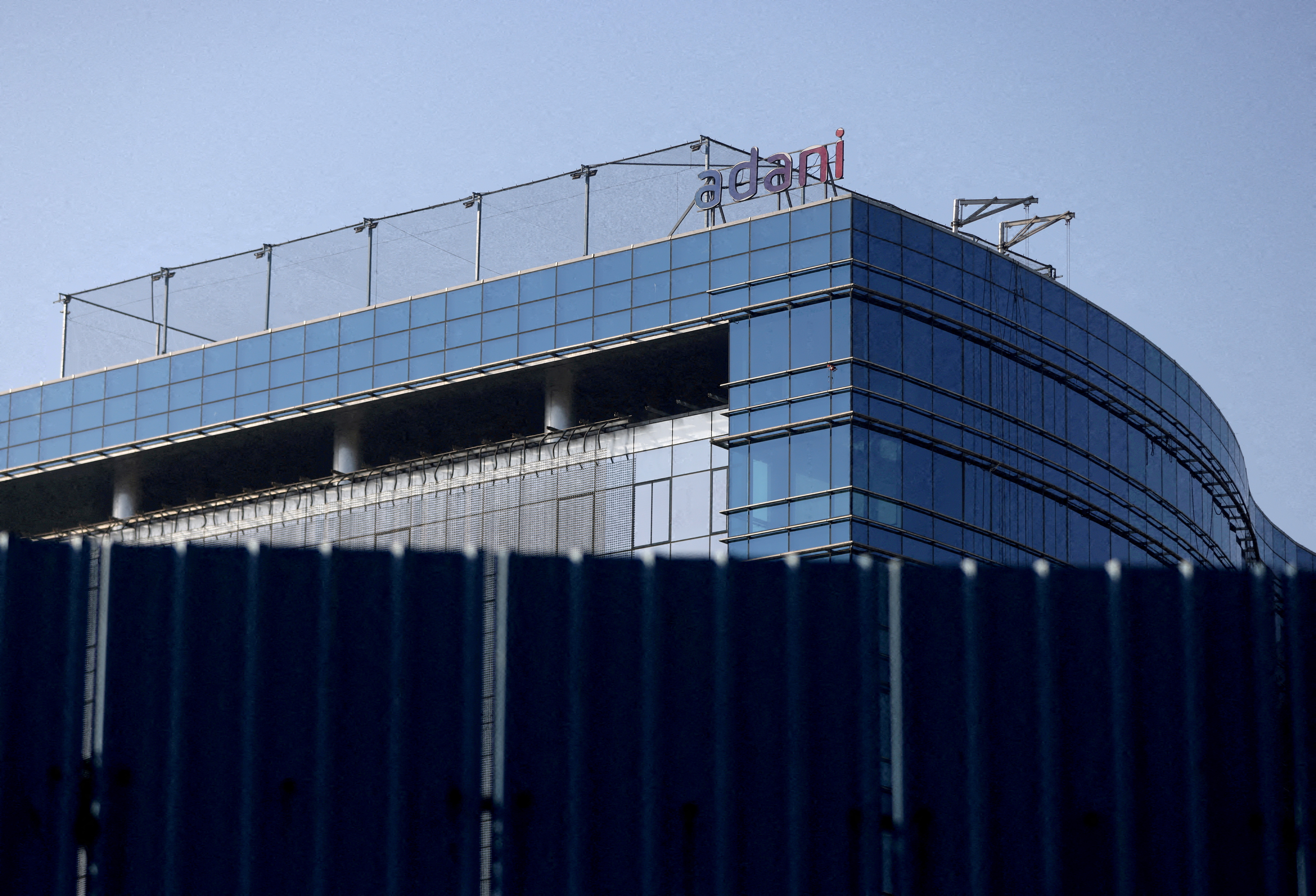 FILE PHOTO: FILE PHOTO: A logo of the Adani Group is seen on a commercial complex in Mumbai