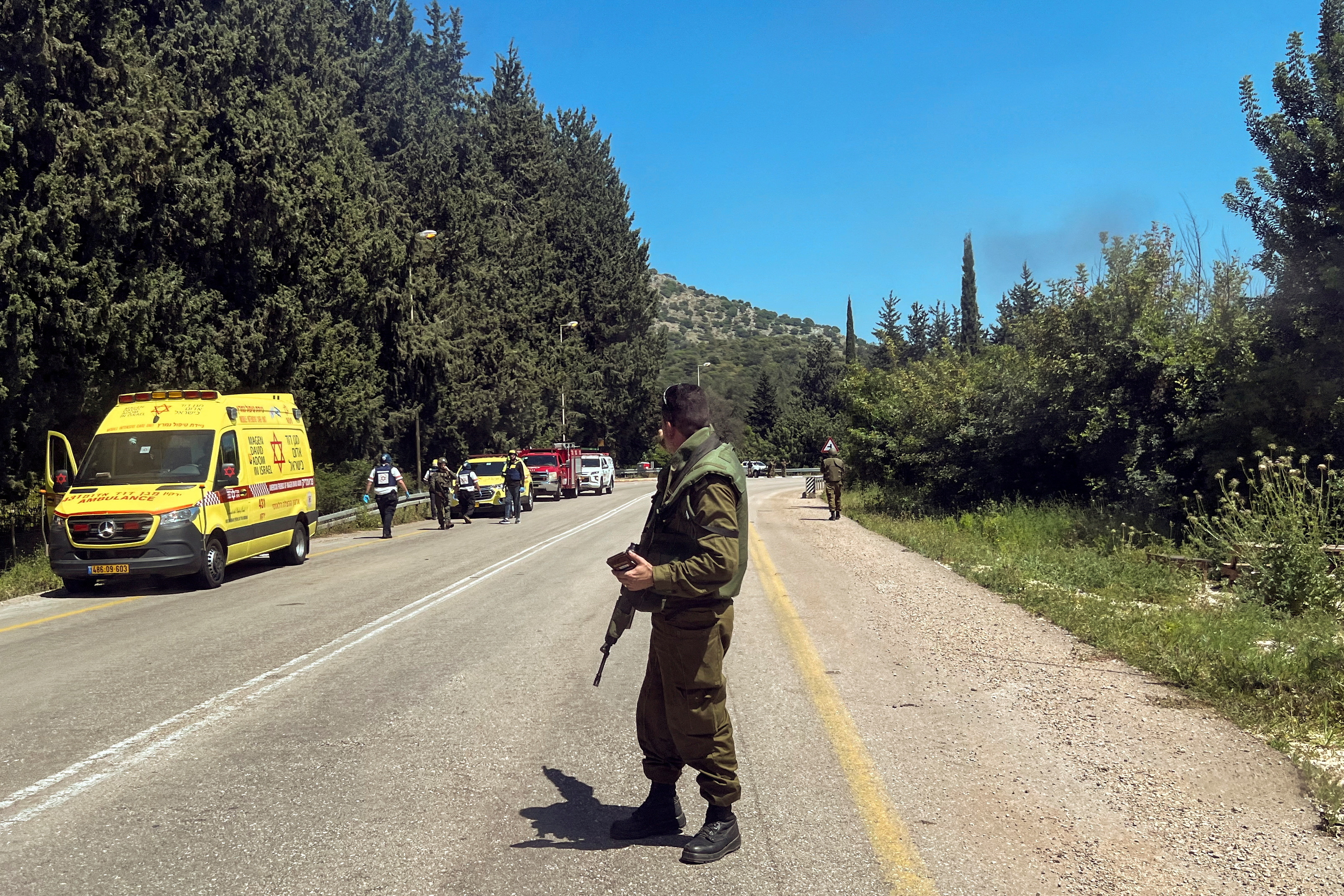 An Israeli soldier looks on after it was reported that people were injured, amid ongoing cross-border hostilities between Hezbollah and Israeli forces, near Arab al-Aramashe