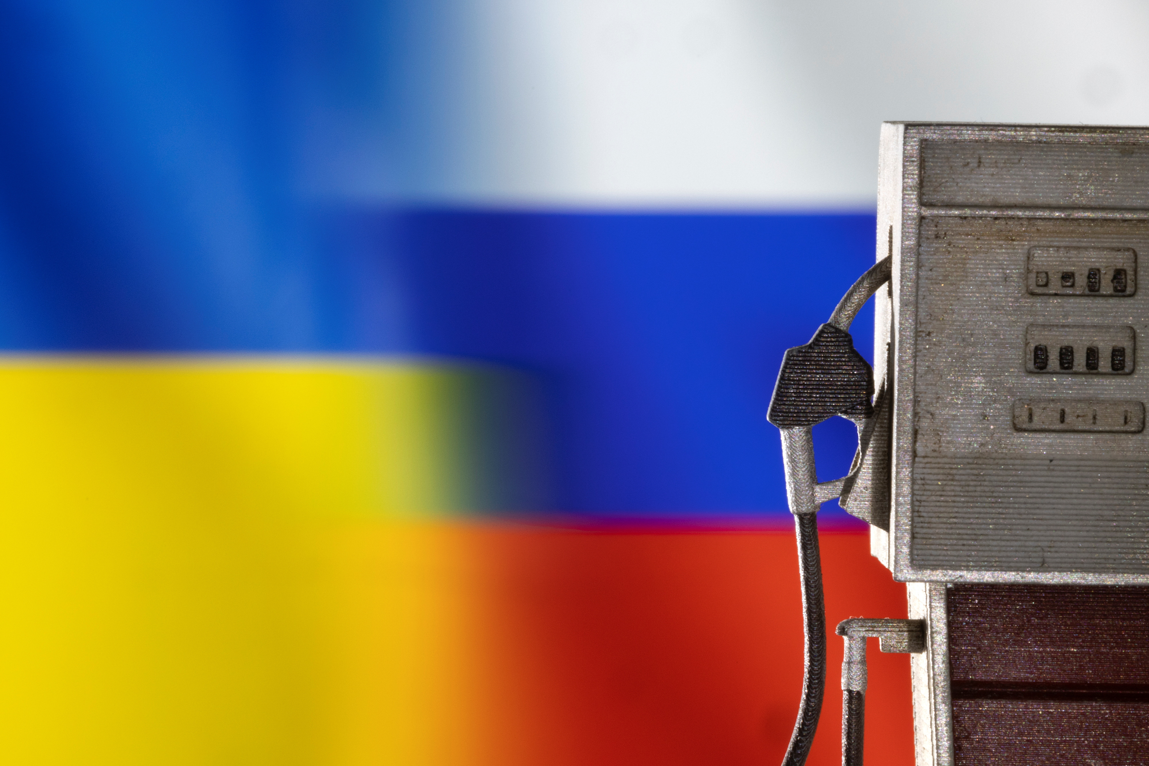Illustration shows model of petrol pump, Ukraine and Russian flag colors
