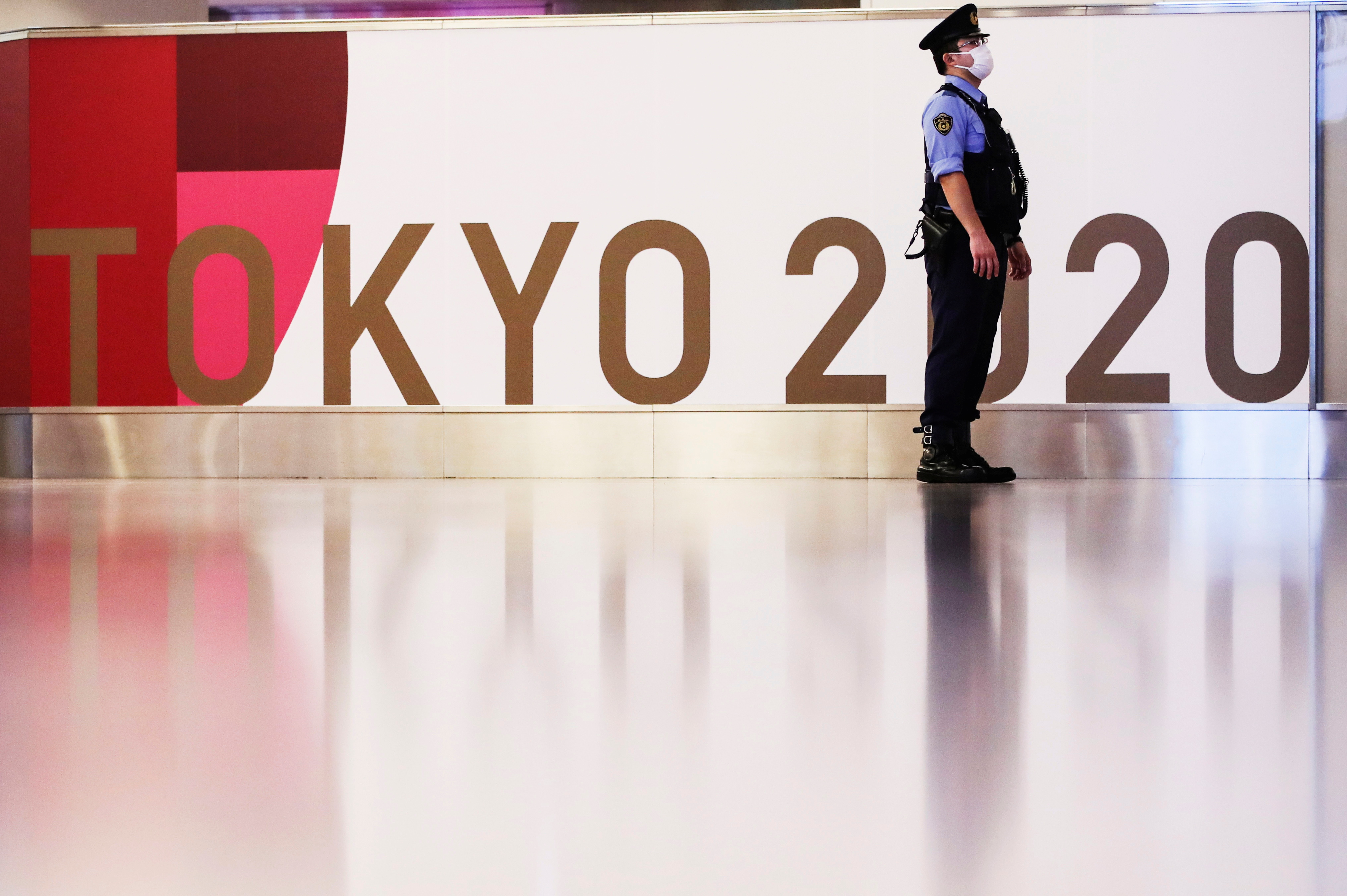 A police officer stands guard before the arrival of IOC President Thomas Bach at Haneda Airport ahead of Tokyo 2020 Olympic Games