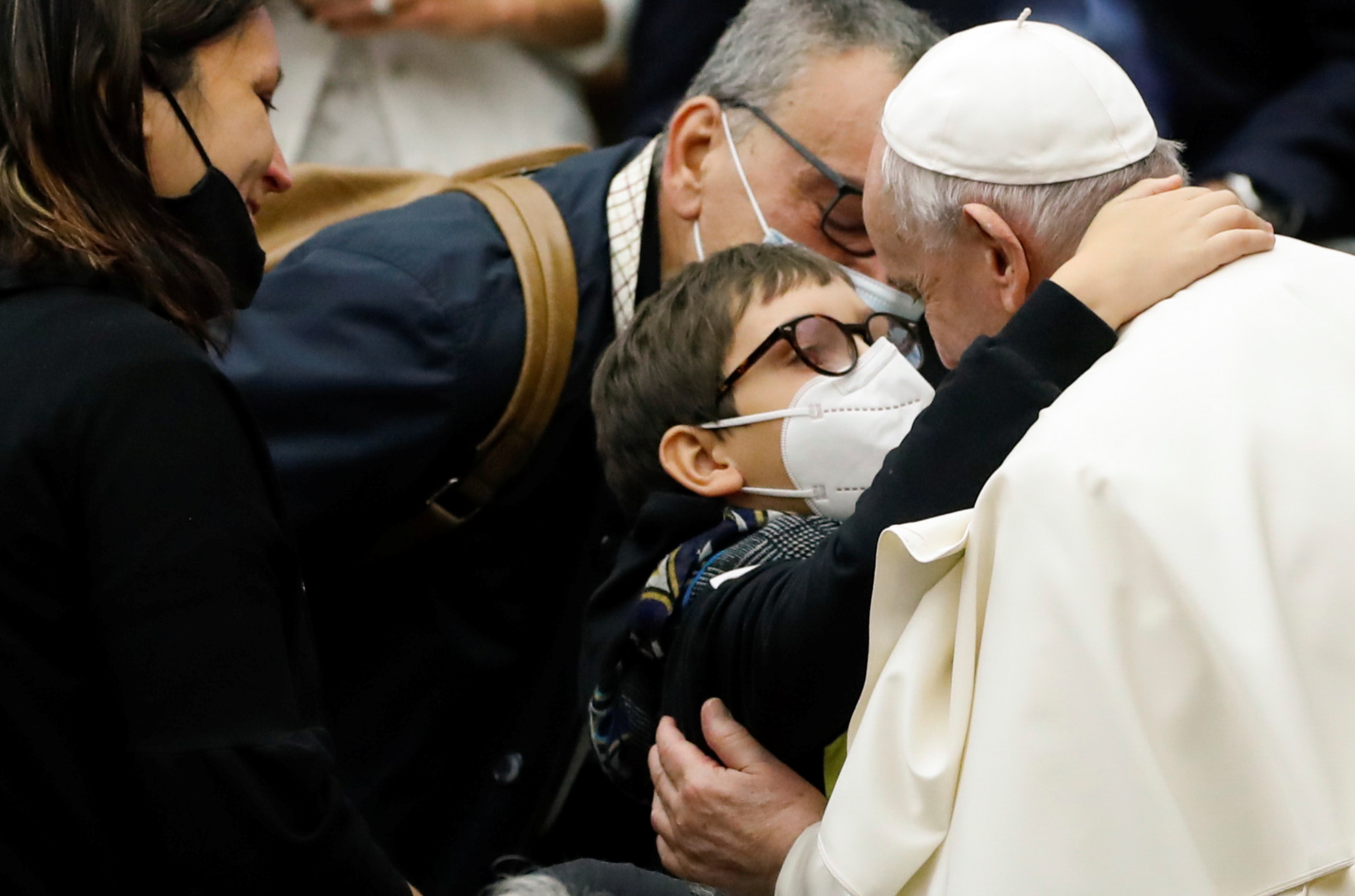 Pope Francis embraces a boy after the weekly general audience at the Vatican, October 20, 2021. REUTERS/Remo Casilli