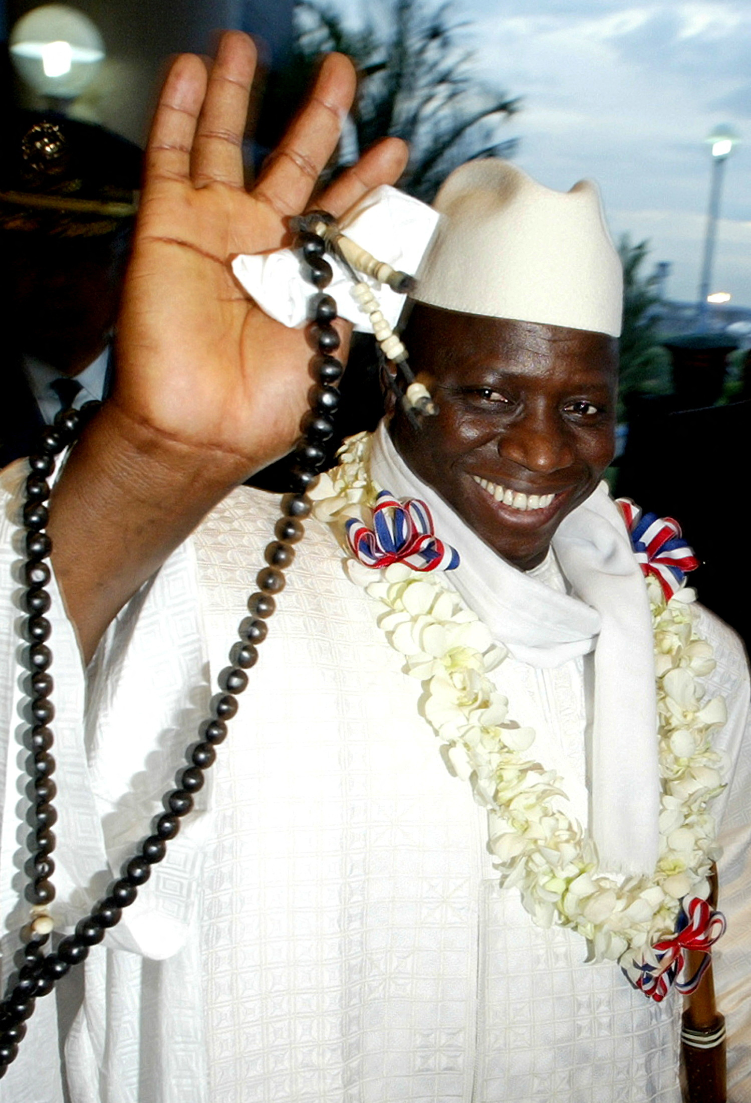Former Gambia President Yahya Jammeh waves during his arrival in Manila. in 2005