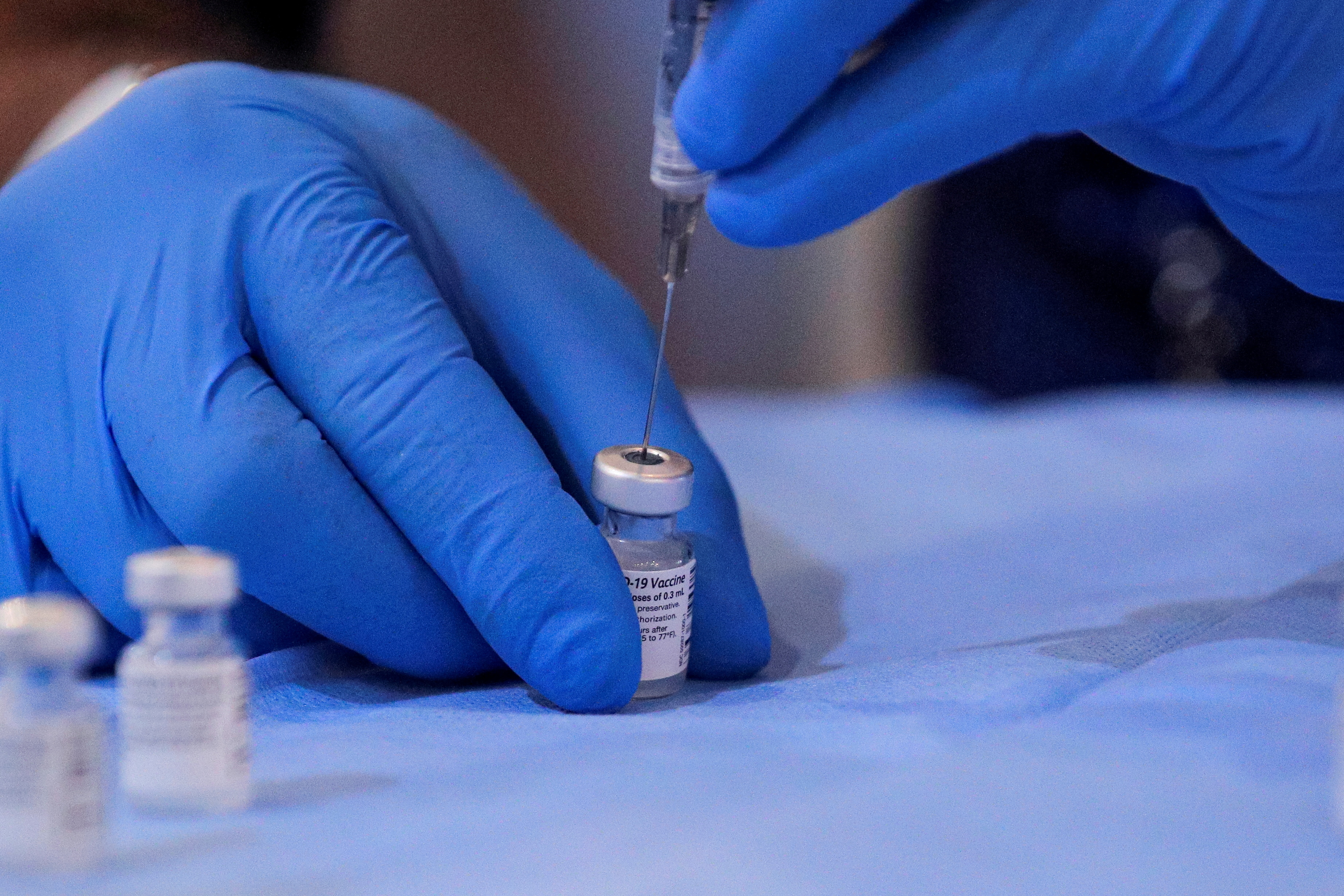A syringe is filled with a dose of Pfizer's coronavirus disease (COVID-19) vaccine at a pop-up community vaccination center in Valley Stream, New York