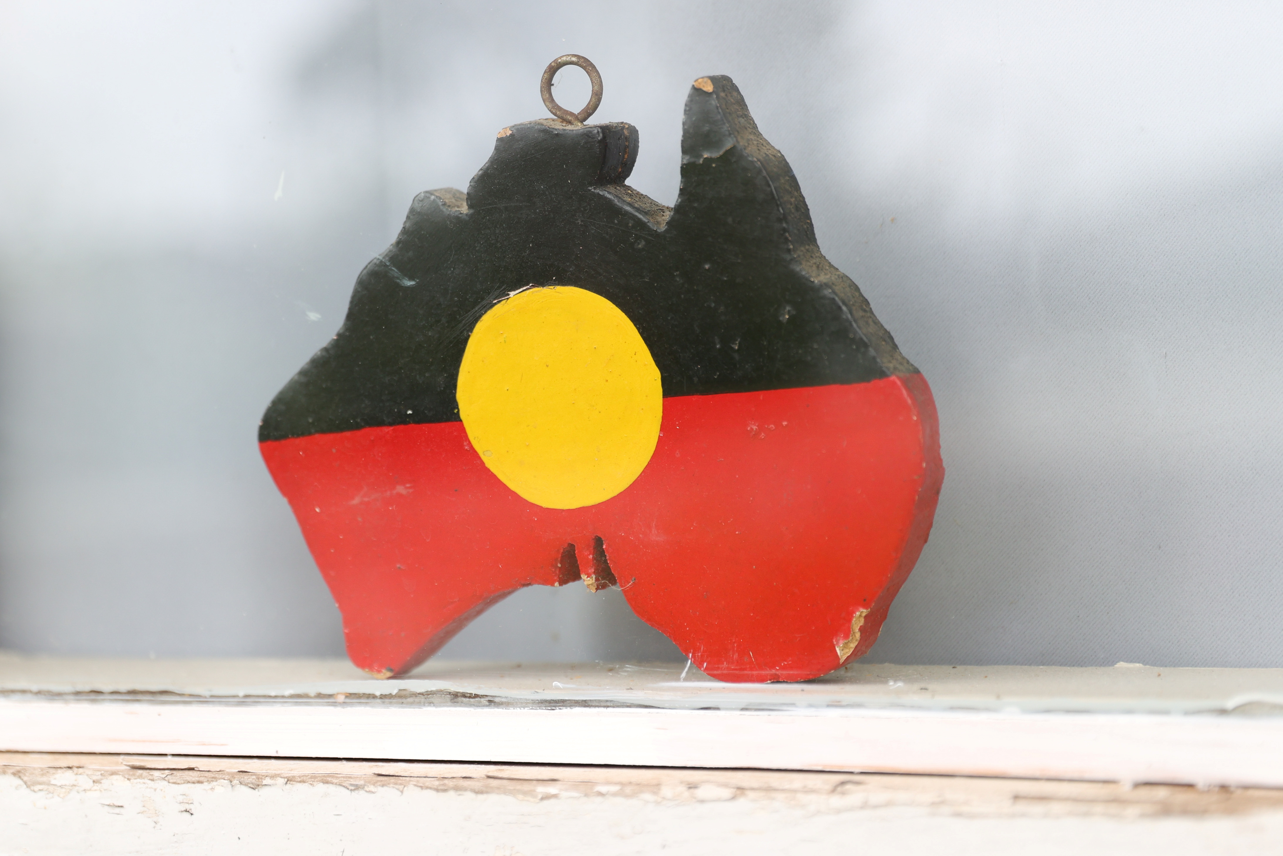 A depiction of the Australian Aboriginal Flag is seen on a window sill in Sydney
