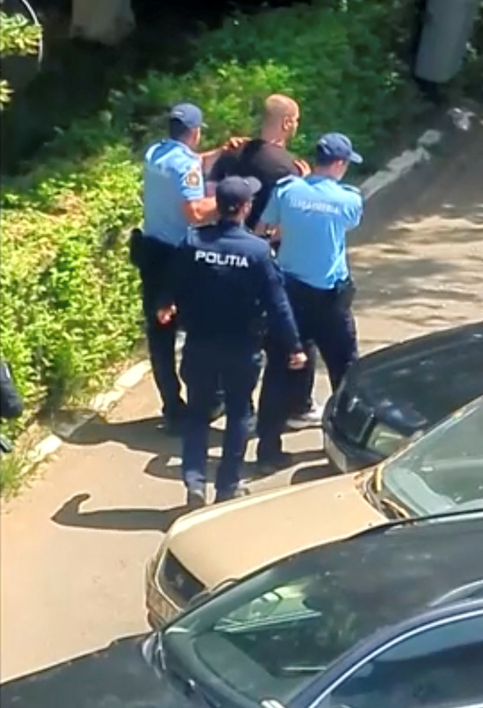 Romanian police escort suspect in Bucharest after Molotov cocktail was thrown at Israeli embassy