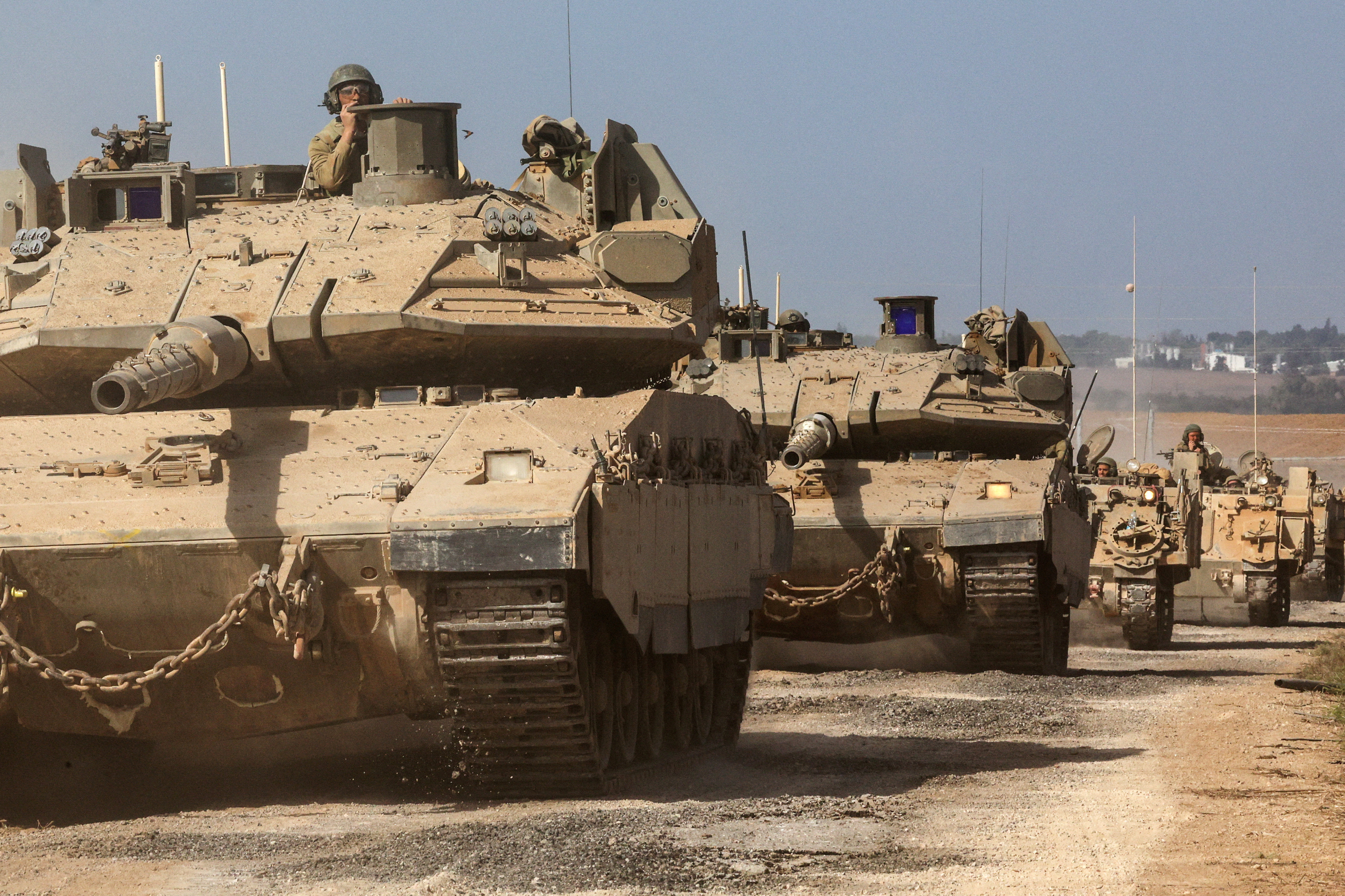 Israeli tanks and military vehicles take position near Israel's border with the Gaza Strip, in southern Israel