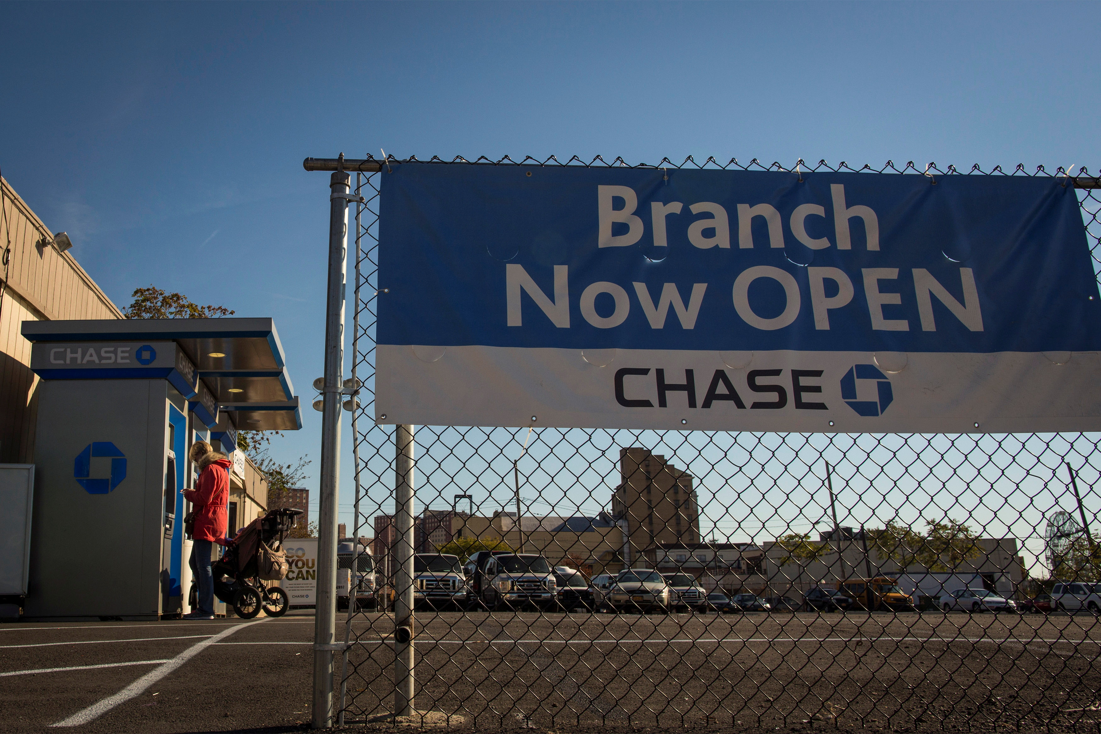 A woman uses an ATM machine outside a temporary building used as a Chase bank branch in Coney Island section of the Brooklyn borough of New York
