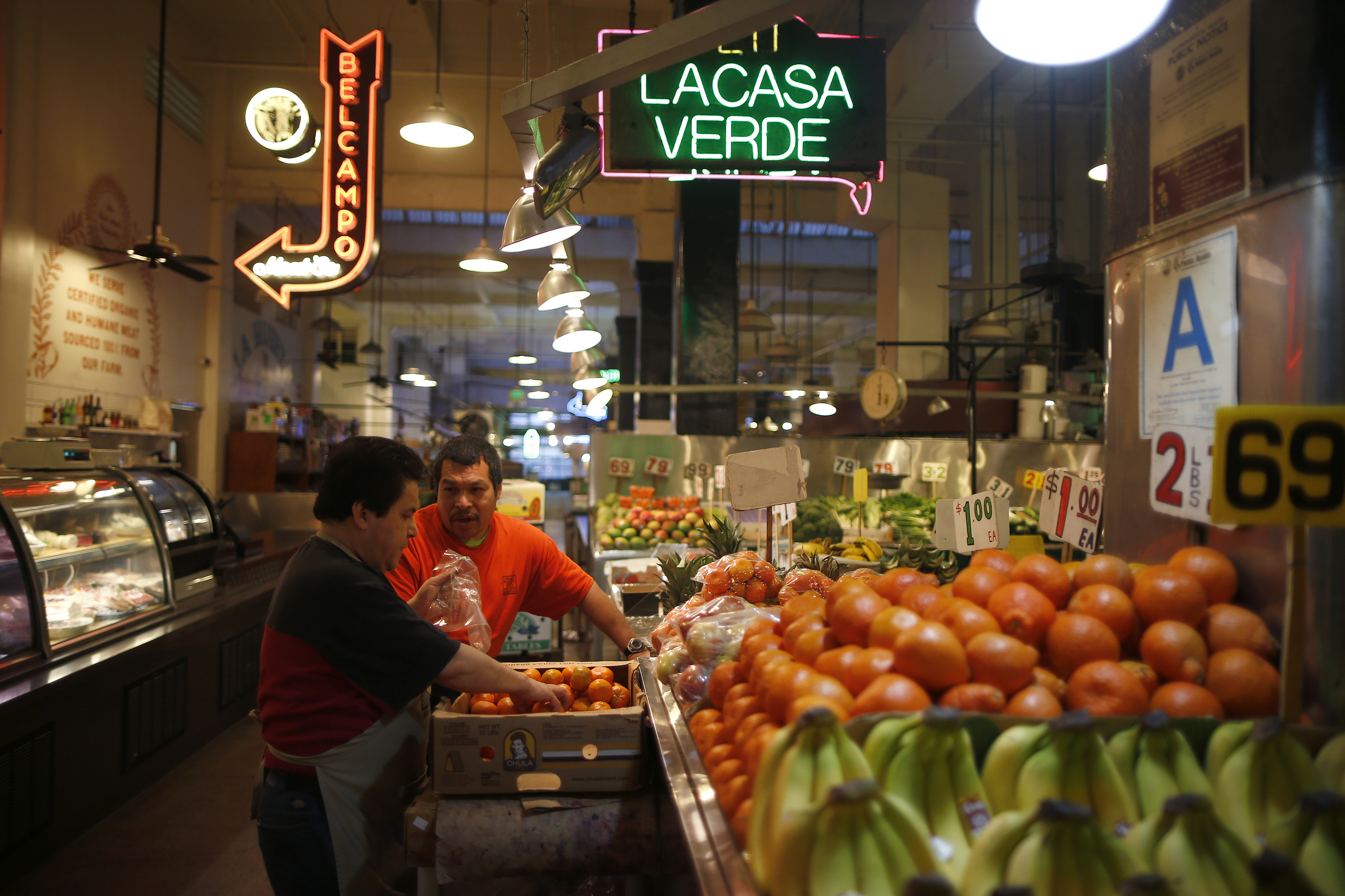 Men unload vegetables at Grand Central Market in Los Angeles