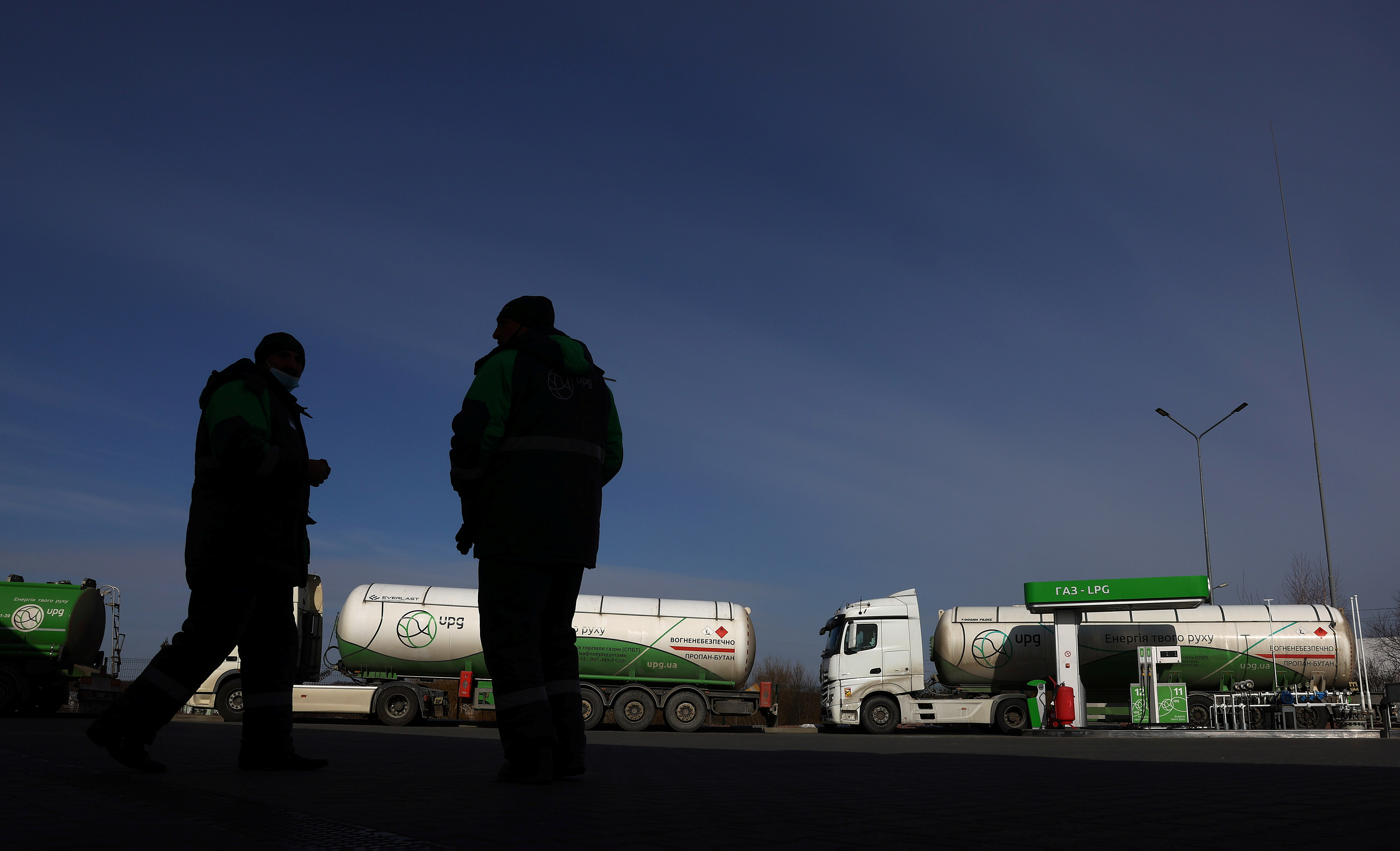 Empty fuel trucks are parked at a gas station on the outskirts of Lviv