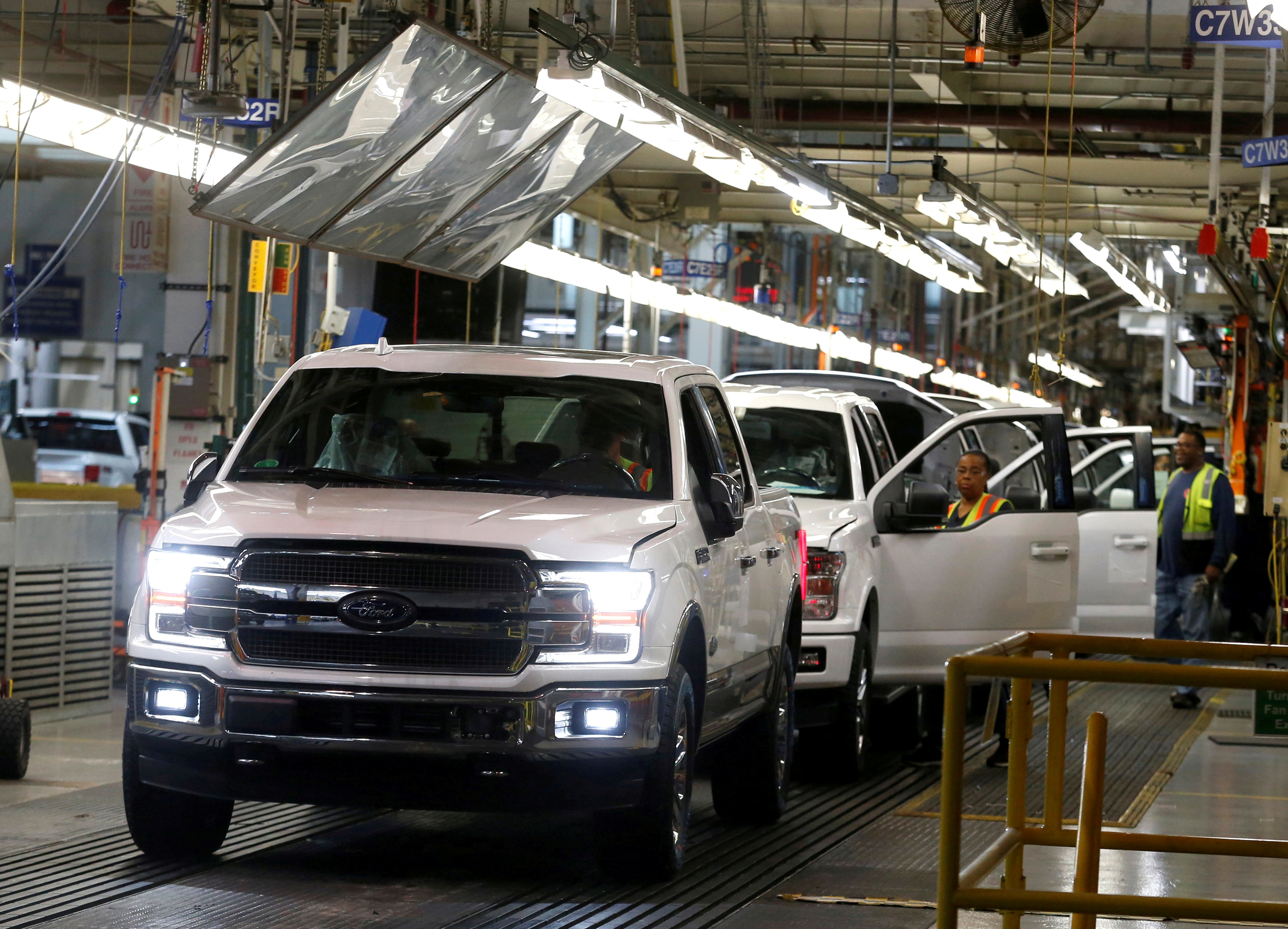 Newly assembled Ford F150 pick-up trucks are driven off the assembly line during the 100-year celebration of the Ford River Rouge Complex in Dearborn