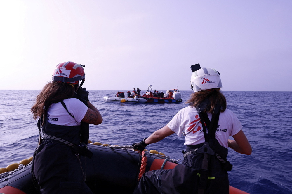 Handout image shows a Medecins Sans Frontieres (MSF) rescue boat near a rubber boat carrying migrants in the Mediterranean Sea