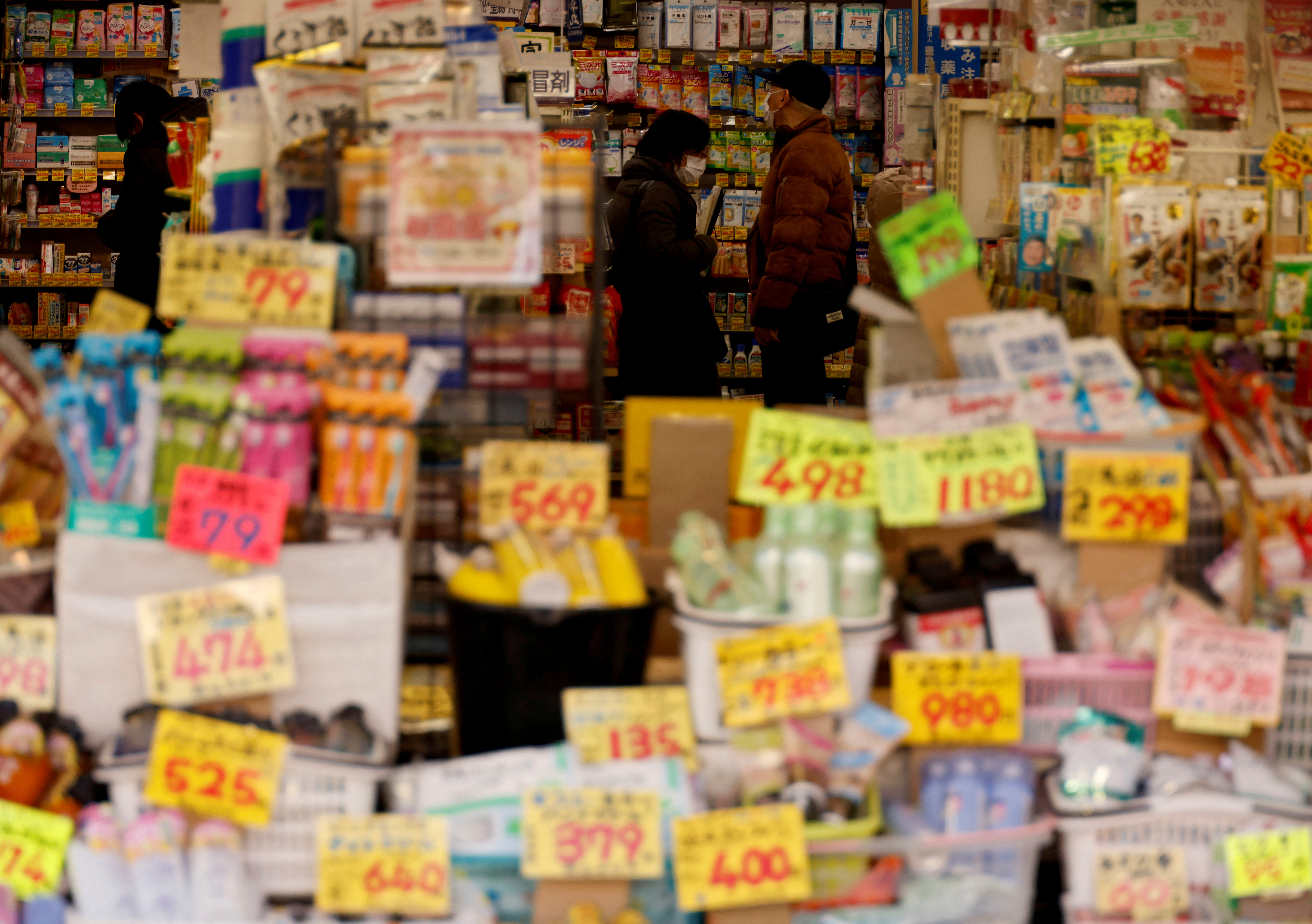 Shoppers choose products at a drug store in Tokyo