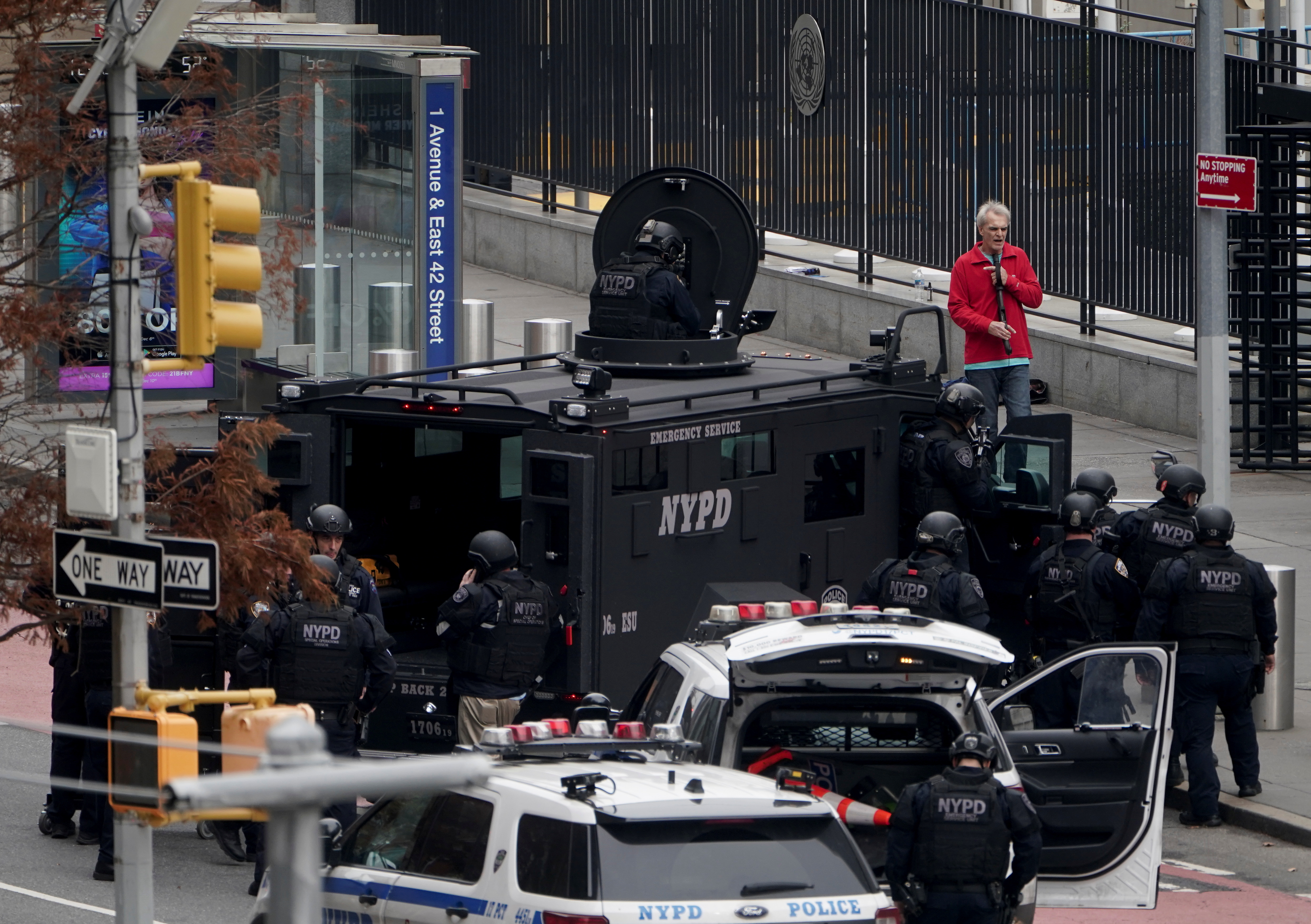 An armed man speaks with member of the NYPD outside the United Nations Headquarters in New York City