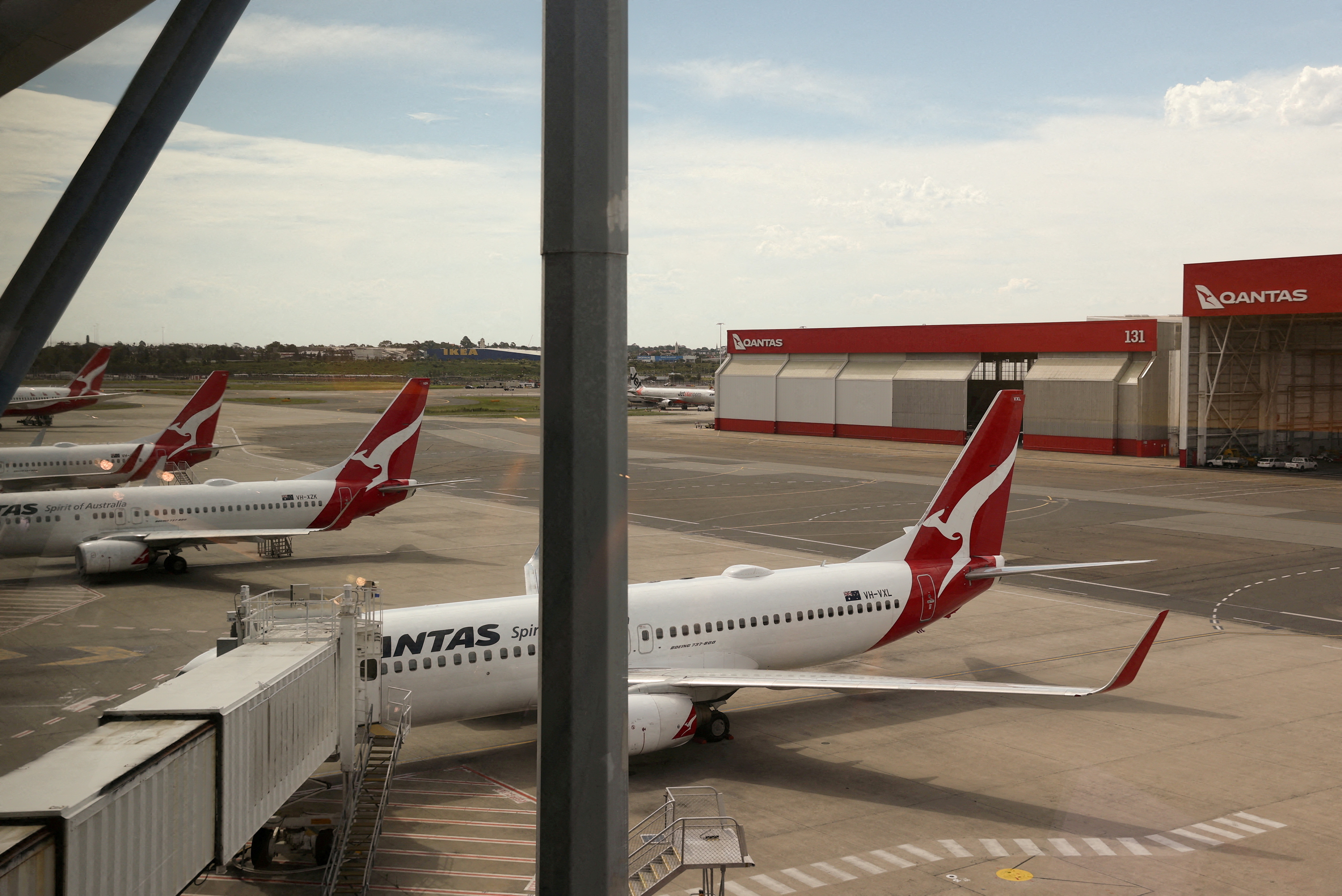Qantas planes are seen at a domestic terminal at Sydney Airport in Sydney