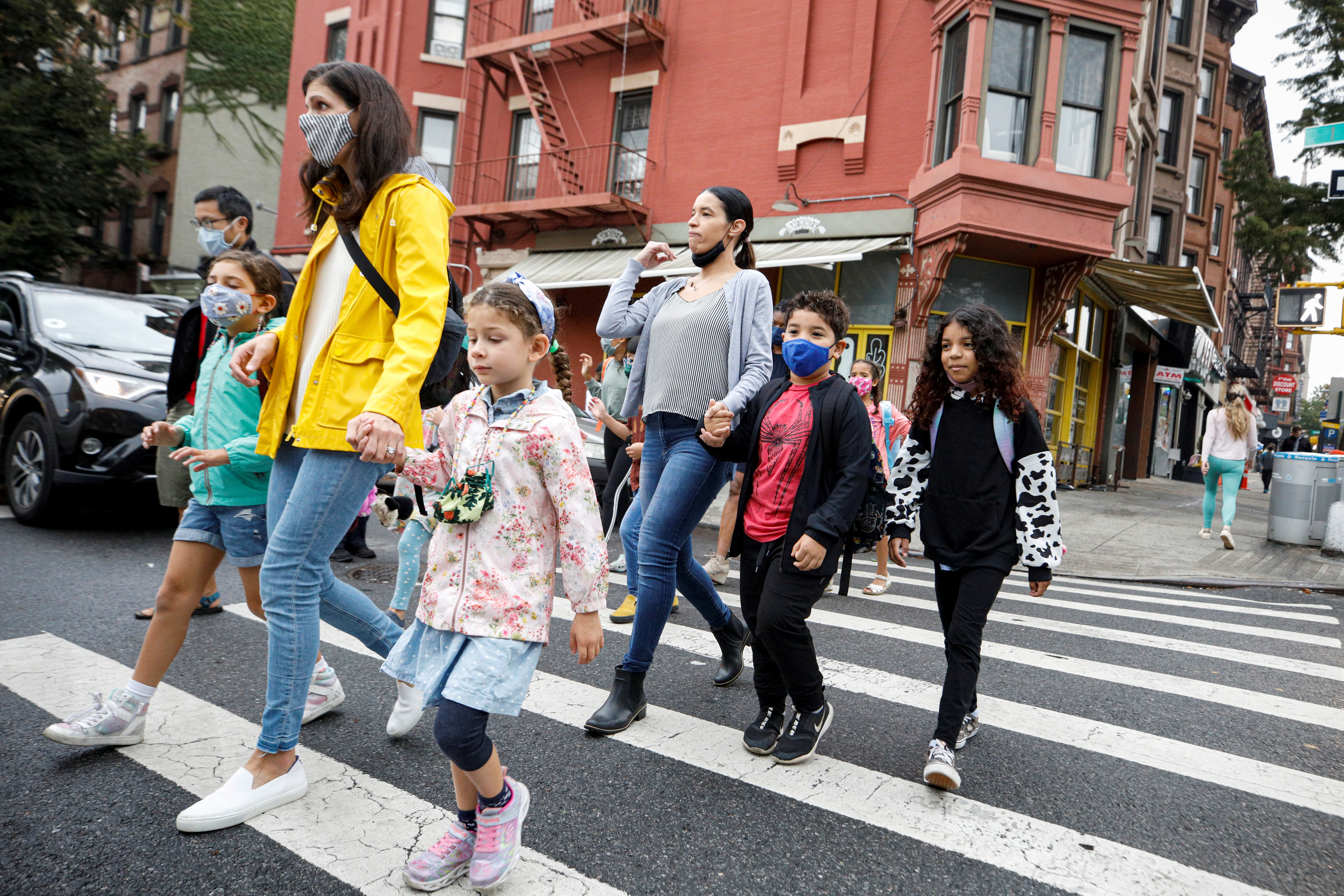 Parents walk with children to school, amid the coronavirus disease (COVID-19) pandemic in Brooklyn, New York