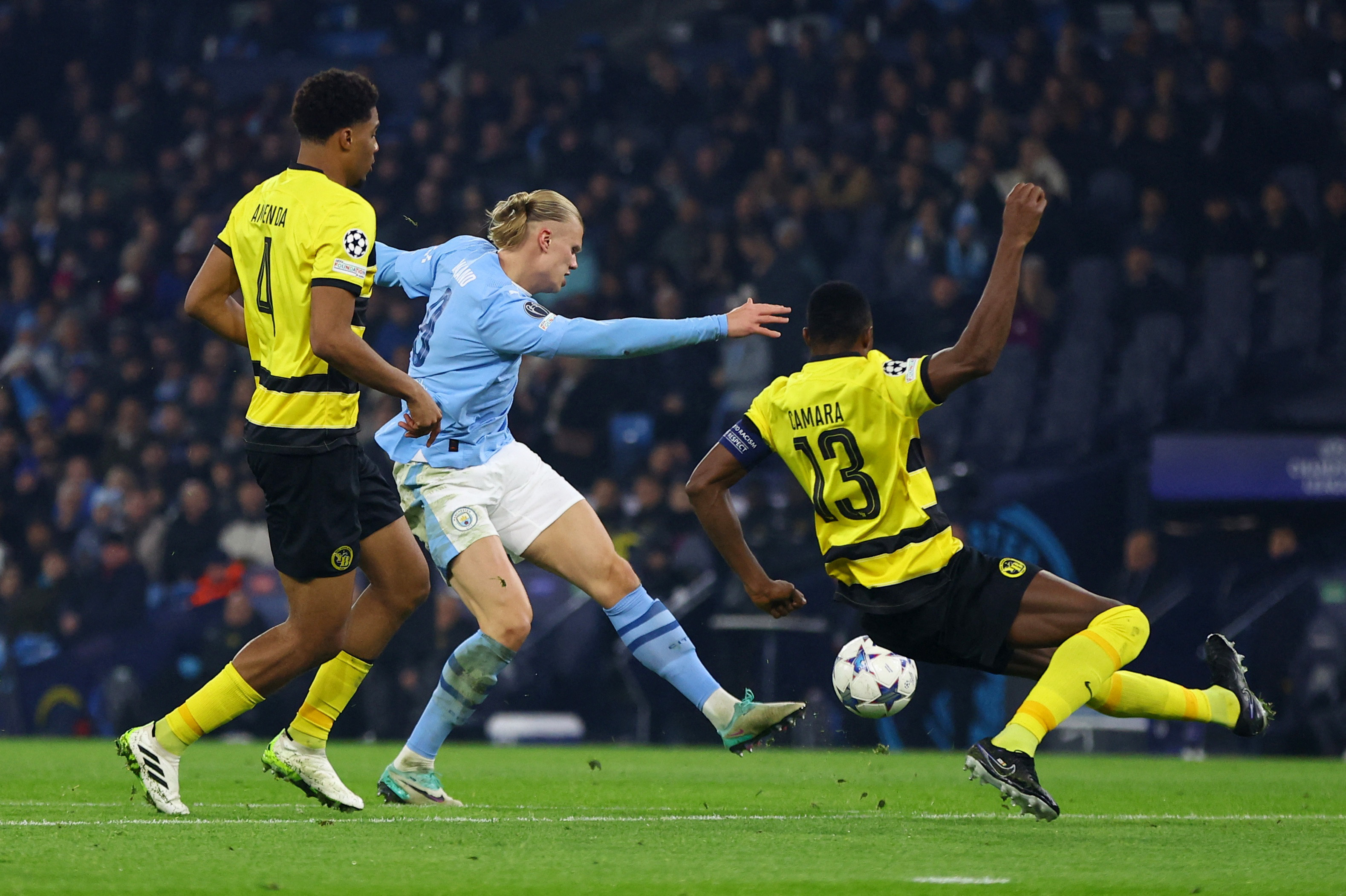 Haaland scores twice as Man City clinch Champions League last 16 place | Reuters