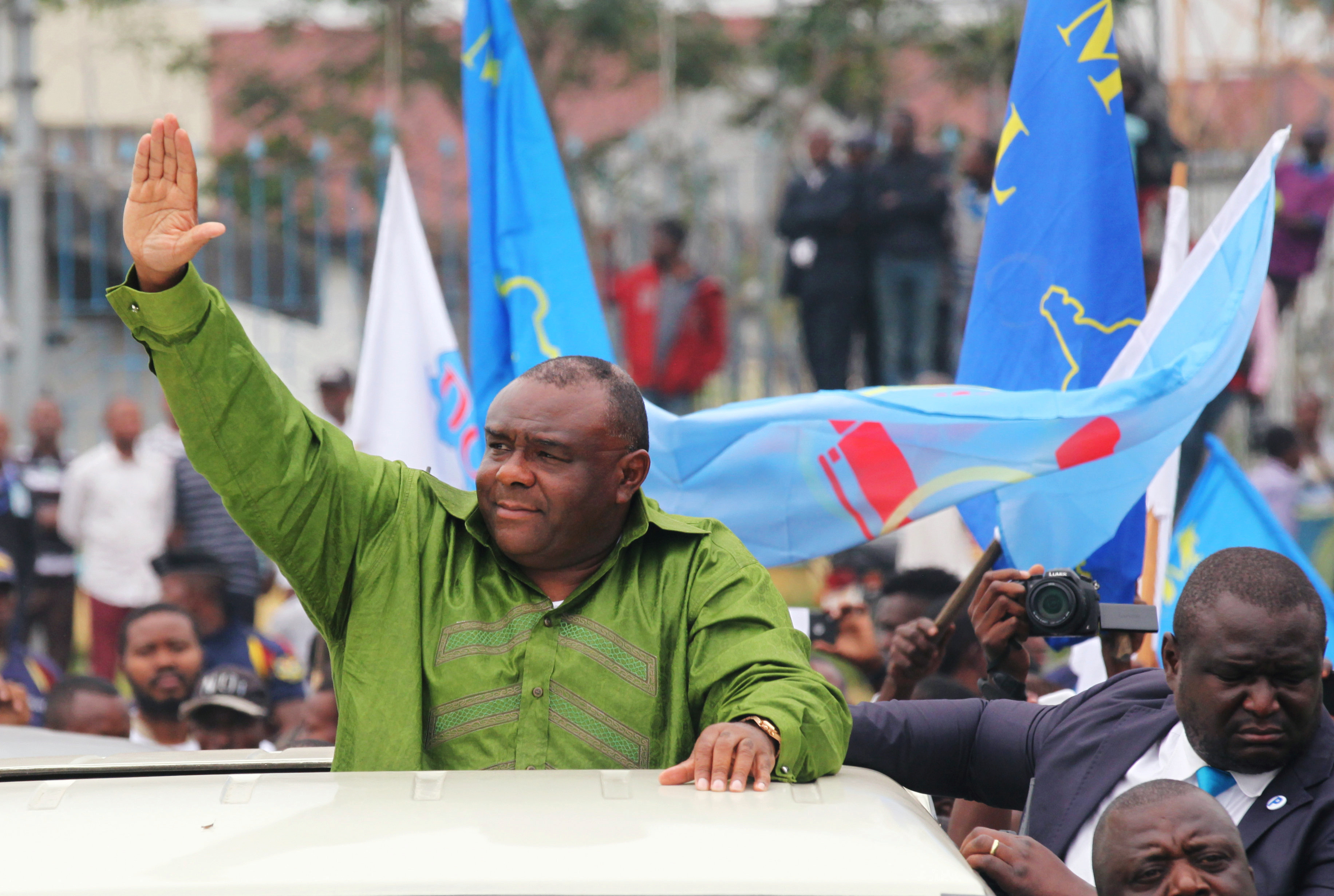 Congolese opposition leader Jean-Pierre Bemba of the Movement for the Liberation of the Congo (MLC) waves to his supporters as he arrives at the N'djili International Airport in Kinshasa