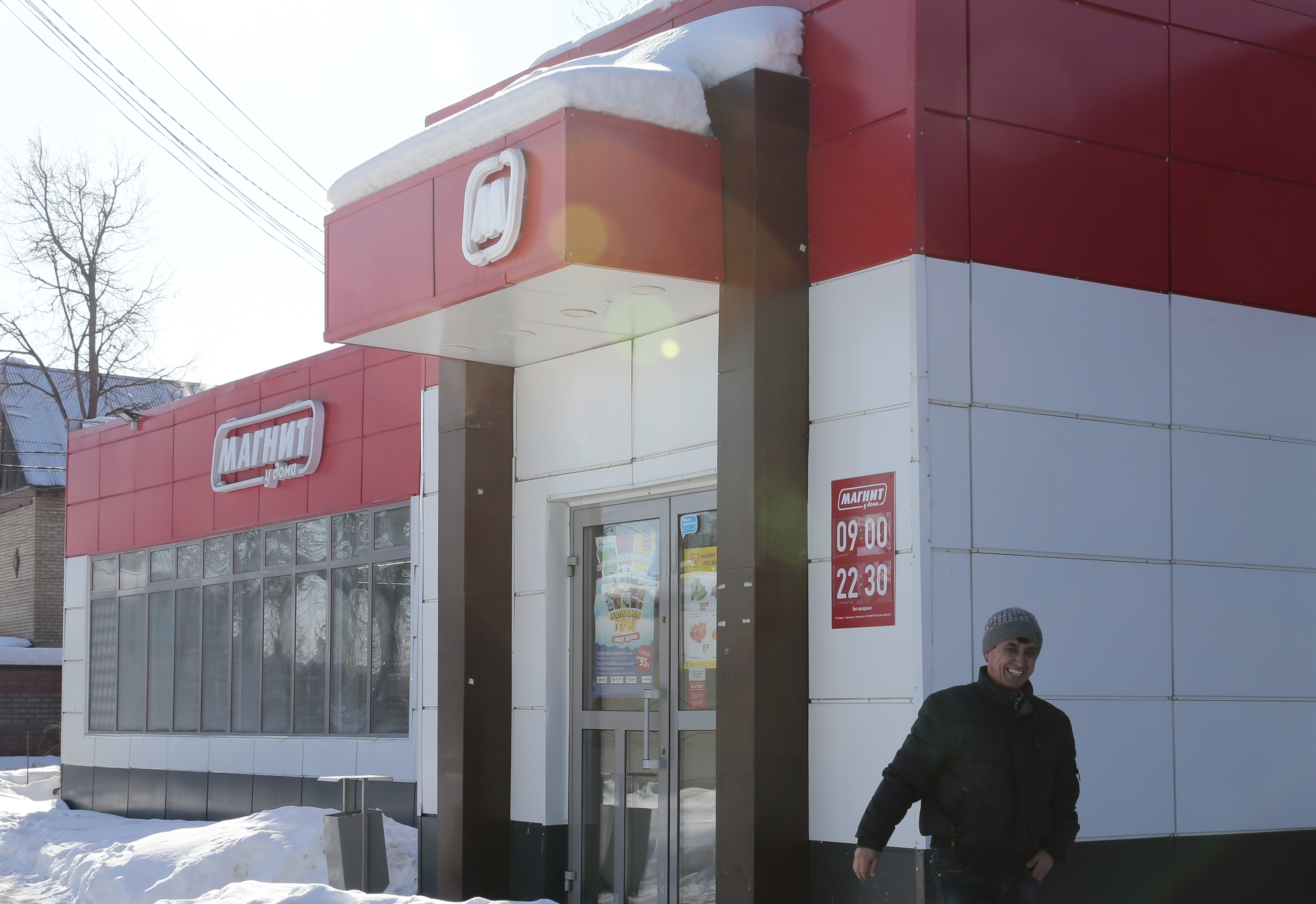 A man walks near a grocery store owned by Russian retailer Magnit outside Moscow
