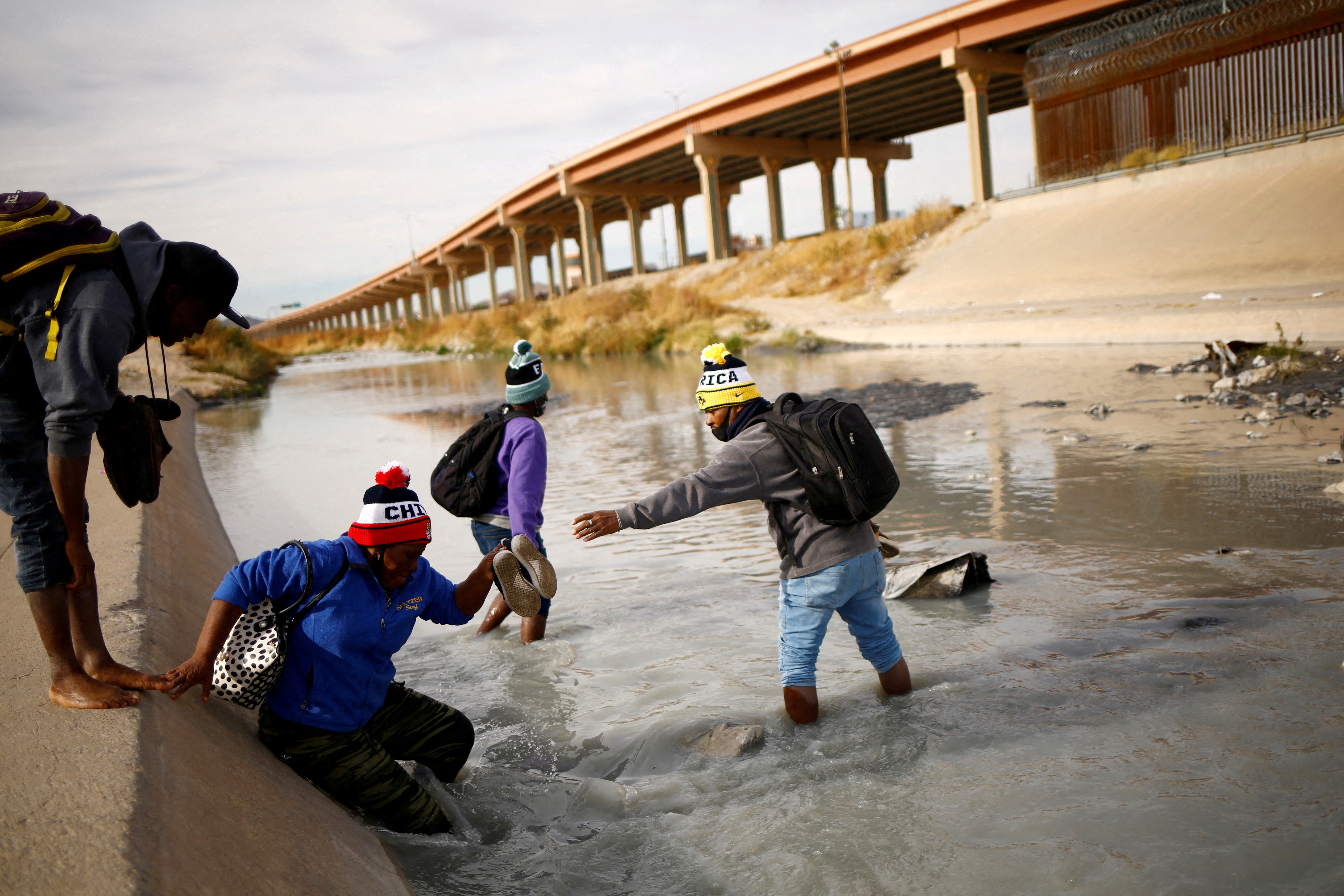 Asylum-seeking migrants from Haiti cross the Rio Bravo river to turn themselves in to U.S Border Patrol agents to request asylum in El Paso, Texas, U.S., in Ciudad Juarez