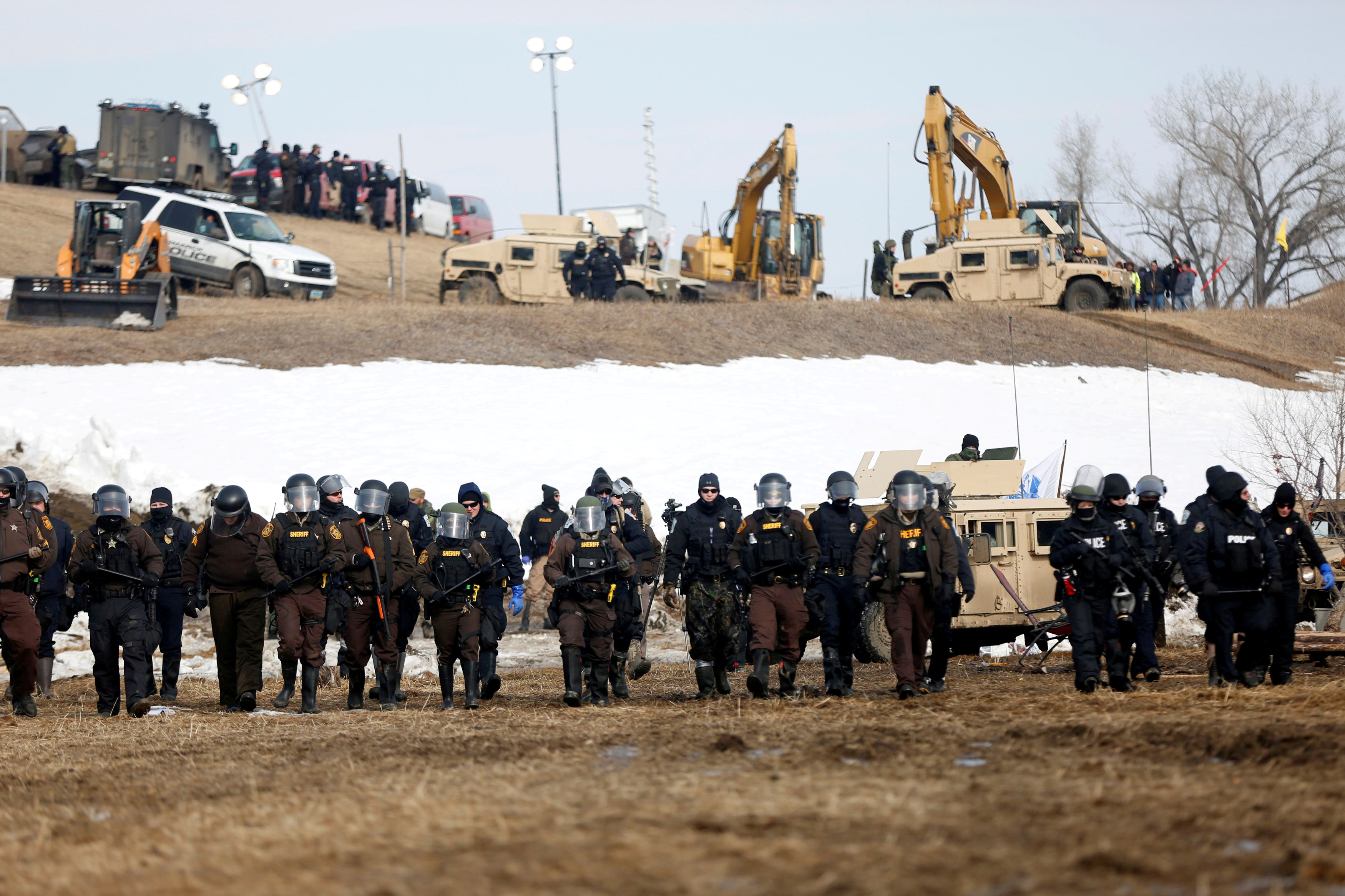 Law enforcement officers advance into the main opposition camp against the Dakota Access oil pipeline near Cannon Ball in 2017