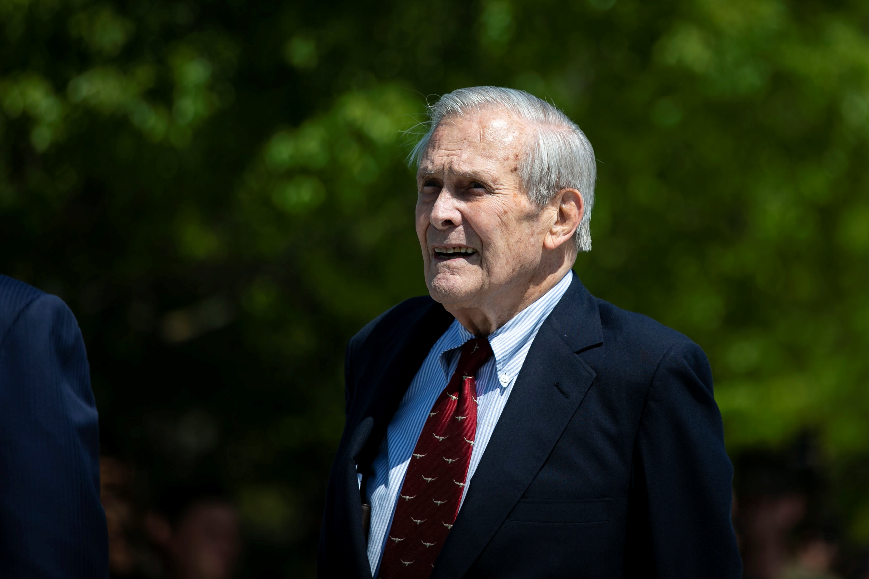 Former U.S. President George W. Bush places a wreath as U.S. Defense Secretary Mark Esper and former U.S. Defense Secretary Donald Rumsfeld look on