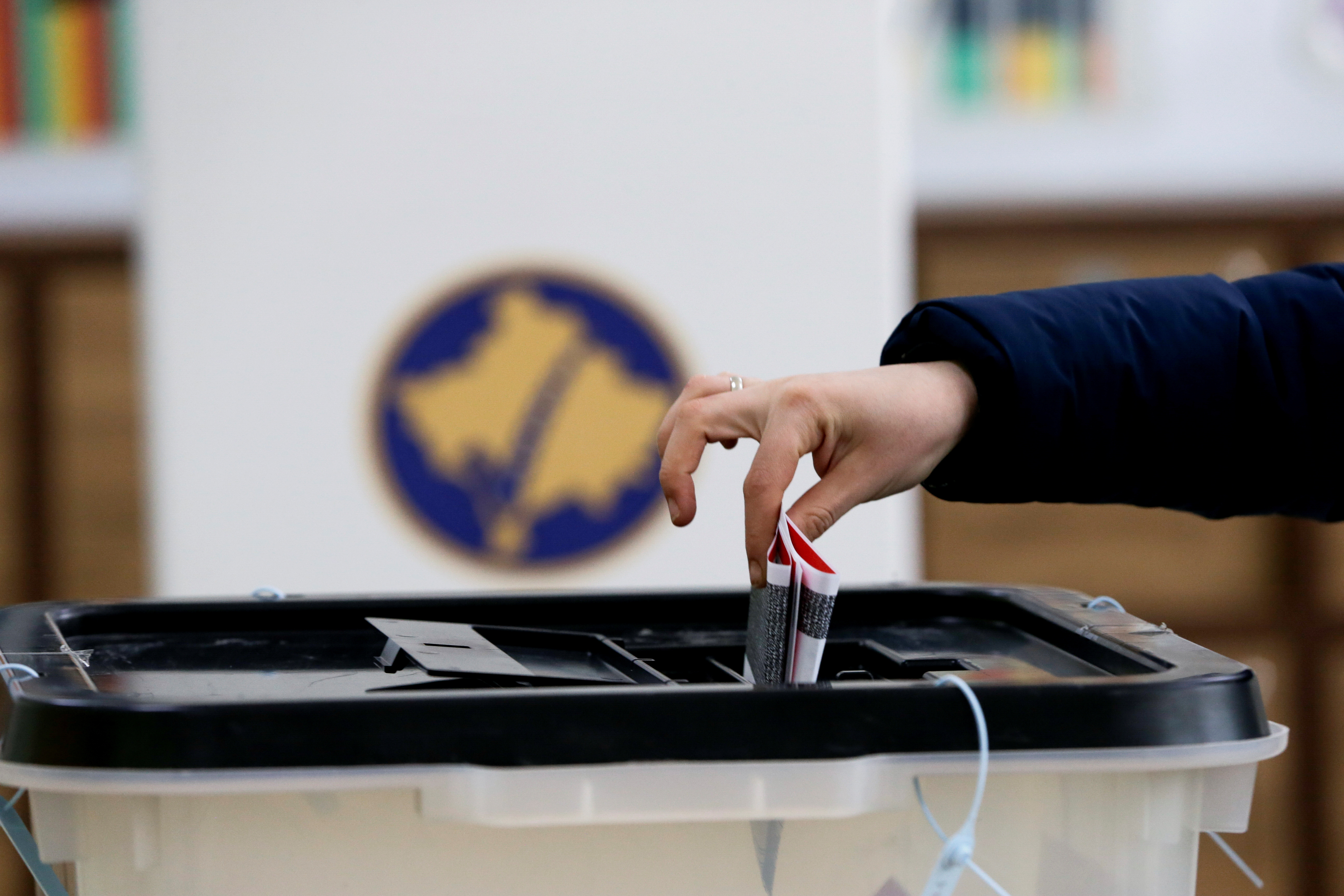 A voter casts a ballot during parliamentary elections in Pristina, Kosovo