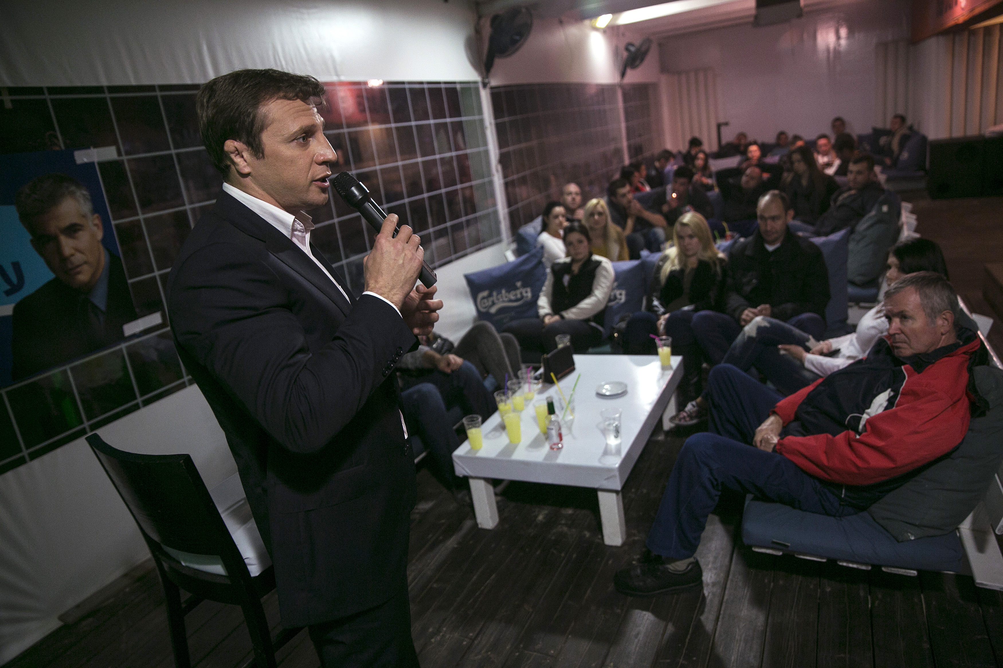 Lawmaker Razvozov addresses Russian-speaking Israelis as he campaigns in a pub in Bat Yam