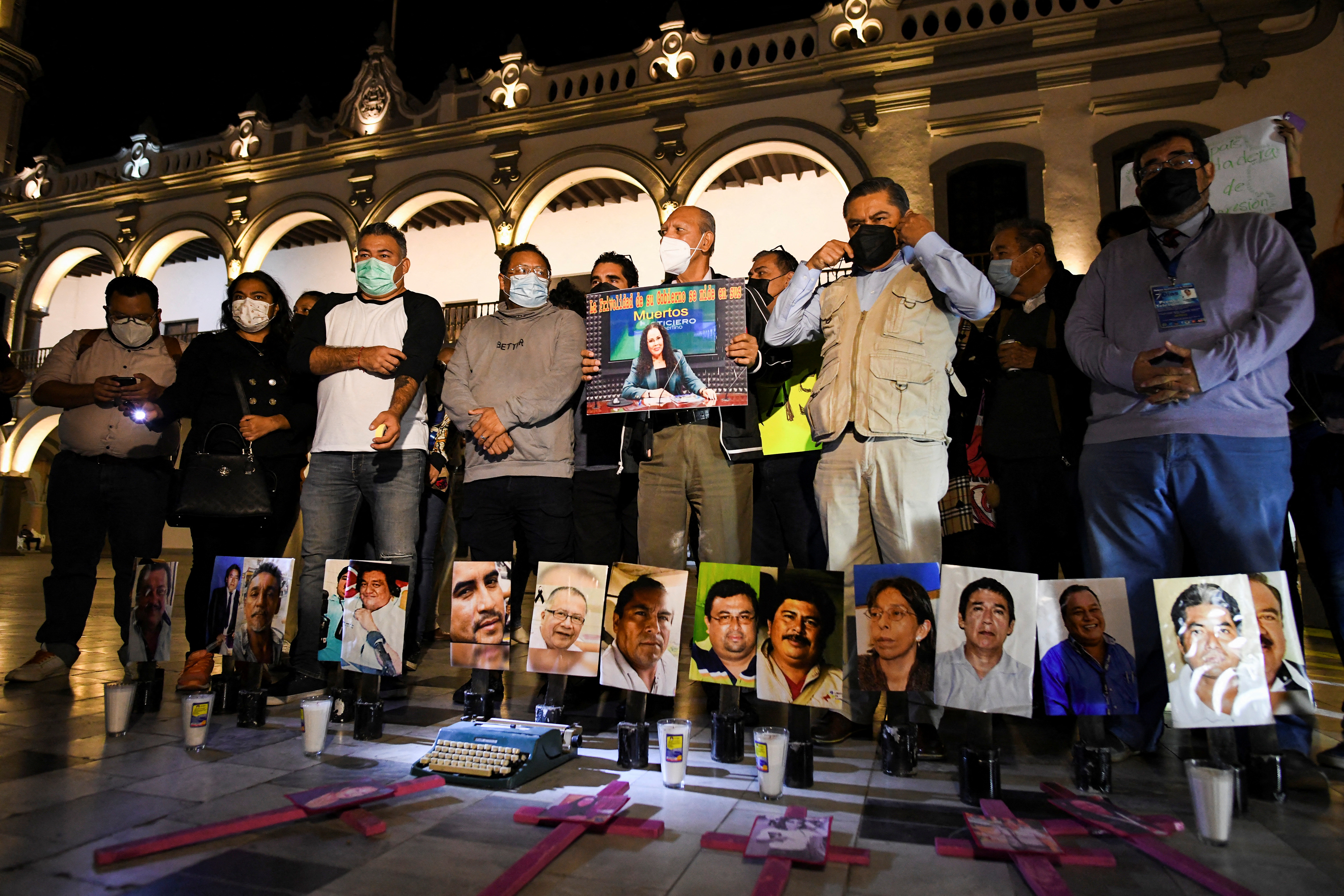 Mexican journalists gather around pictures of colleagues who have been murdered as they protest the recent killings of photojournalist Margarito Martinez and journalist Lourdes Maldonado, in Veracruz, Mexico January 25, 2022. REUTERS/Yahir Ceballos