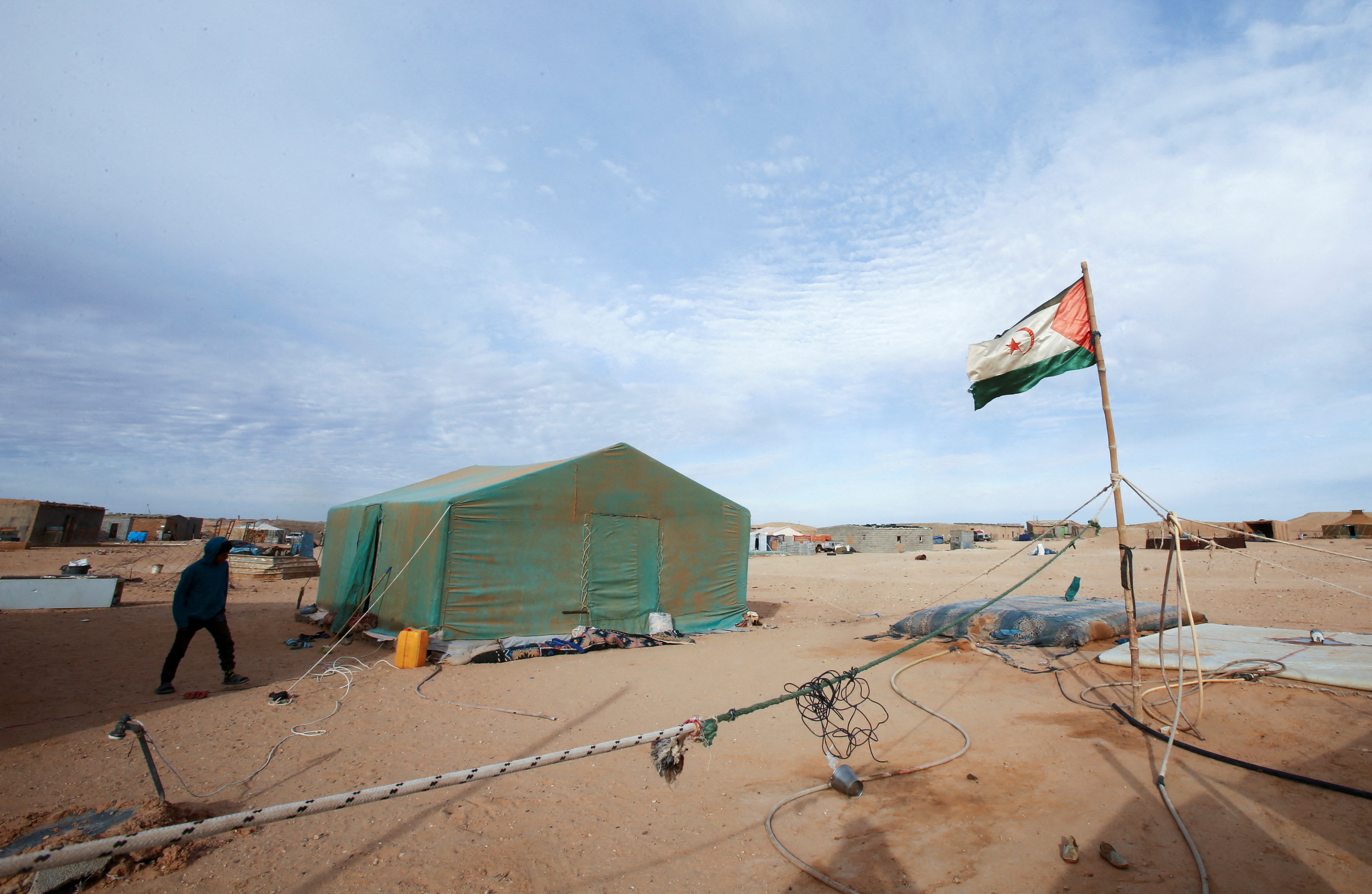 A person walks past tents at a Sahrawi refugee camp in Tindouf