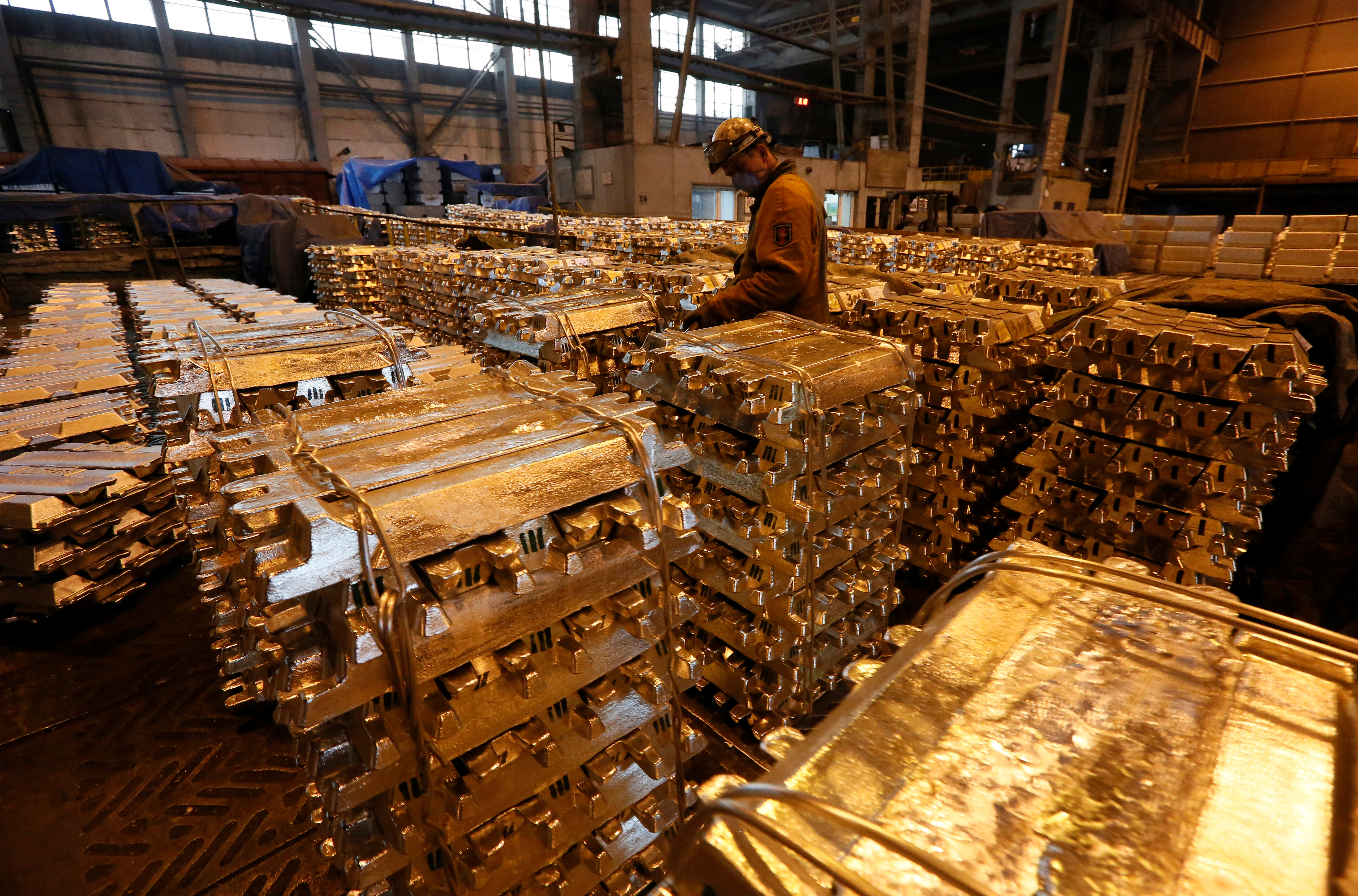 A worker stores aluminium ingots at the foundry shop of the Rusal Krasnoyarsk aluminium smelter in Krasnoyarsk