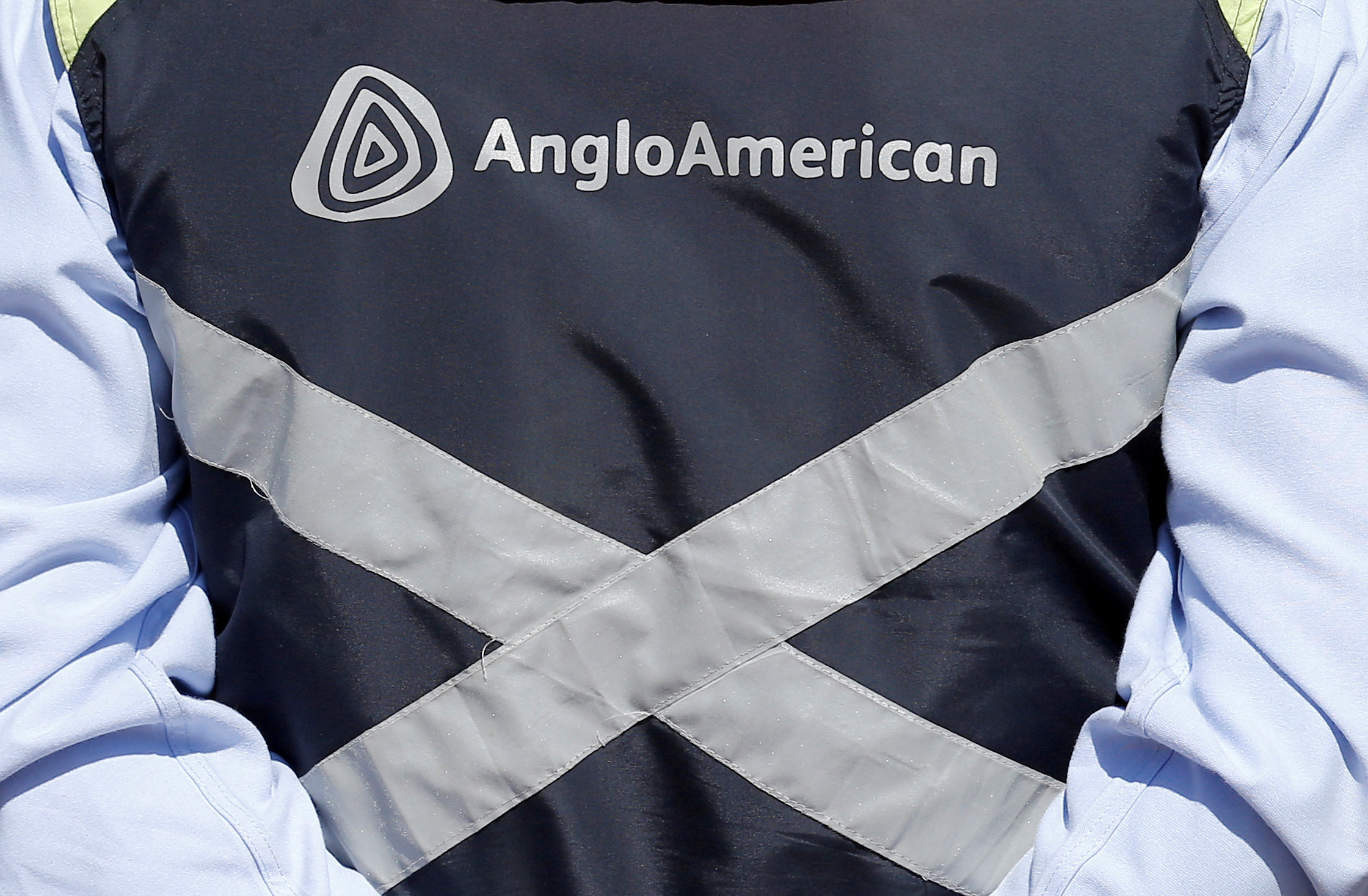 The Anglo American logo is seen on the jacket of an employee of the Los Bronces copper mine on the outskirts of Santiago