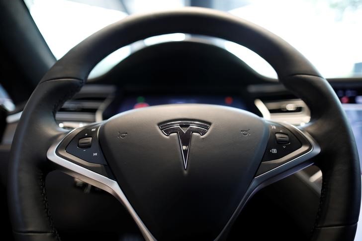 The logo of Tesla is seen on a steering wheel of its Model S electric car at its dealership in Seoul