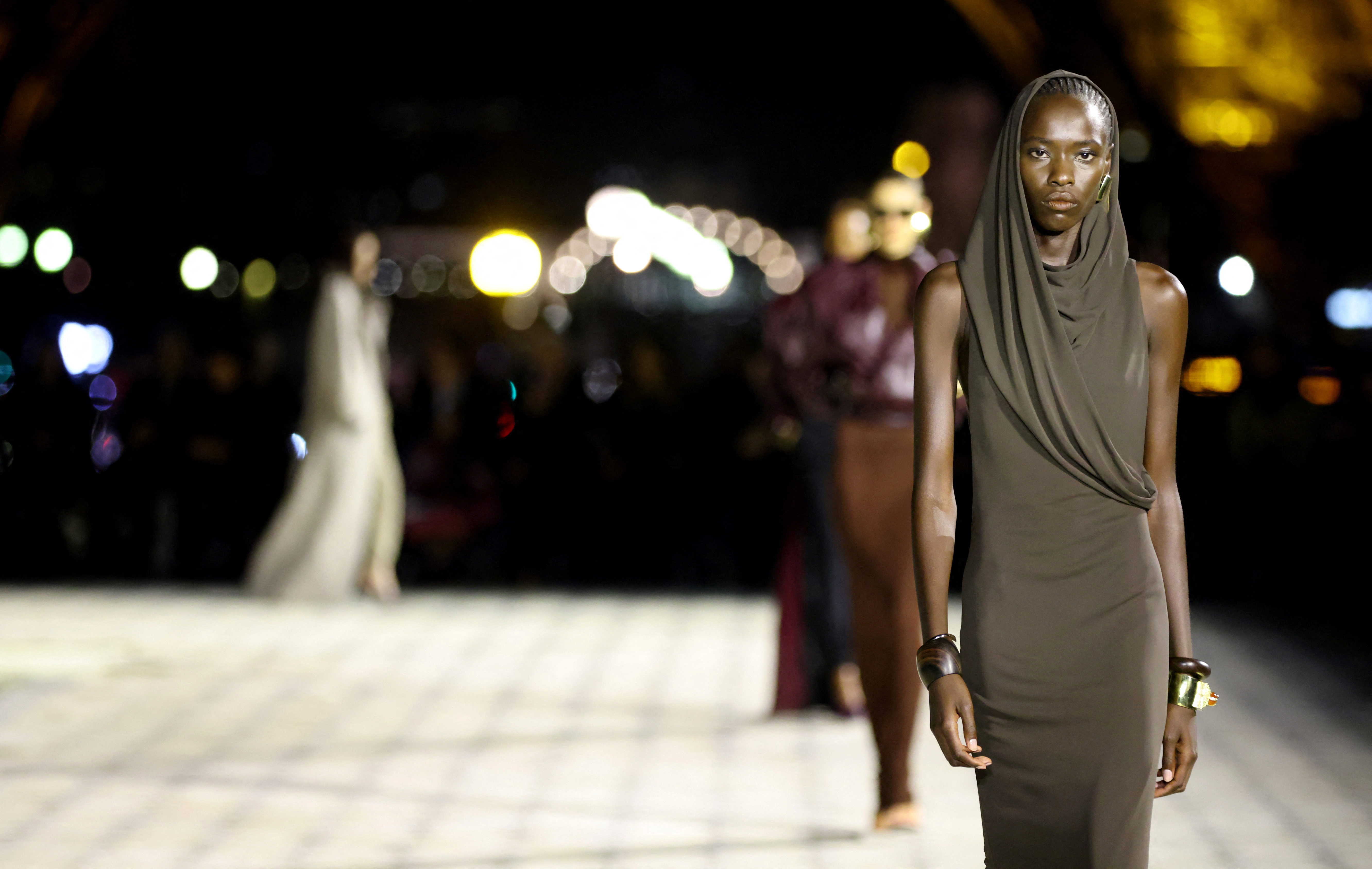 Yves Saint Laurent sends silky evening gowns down Eiffel Tower runway