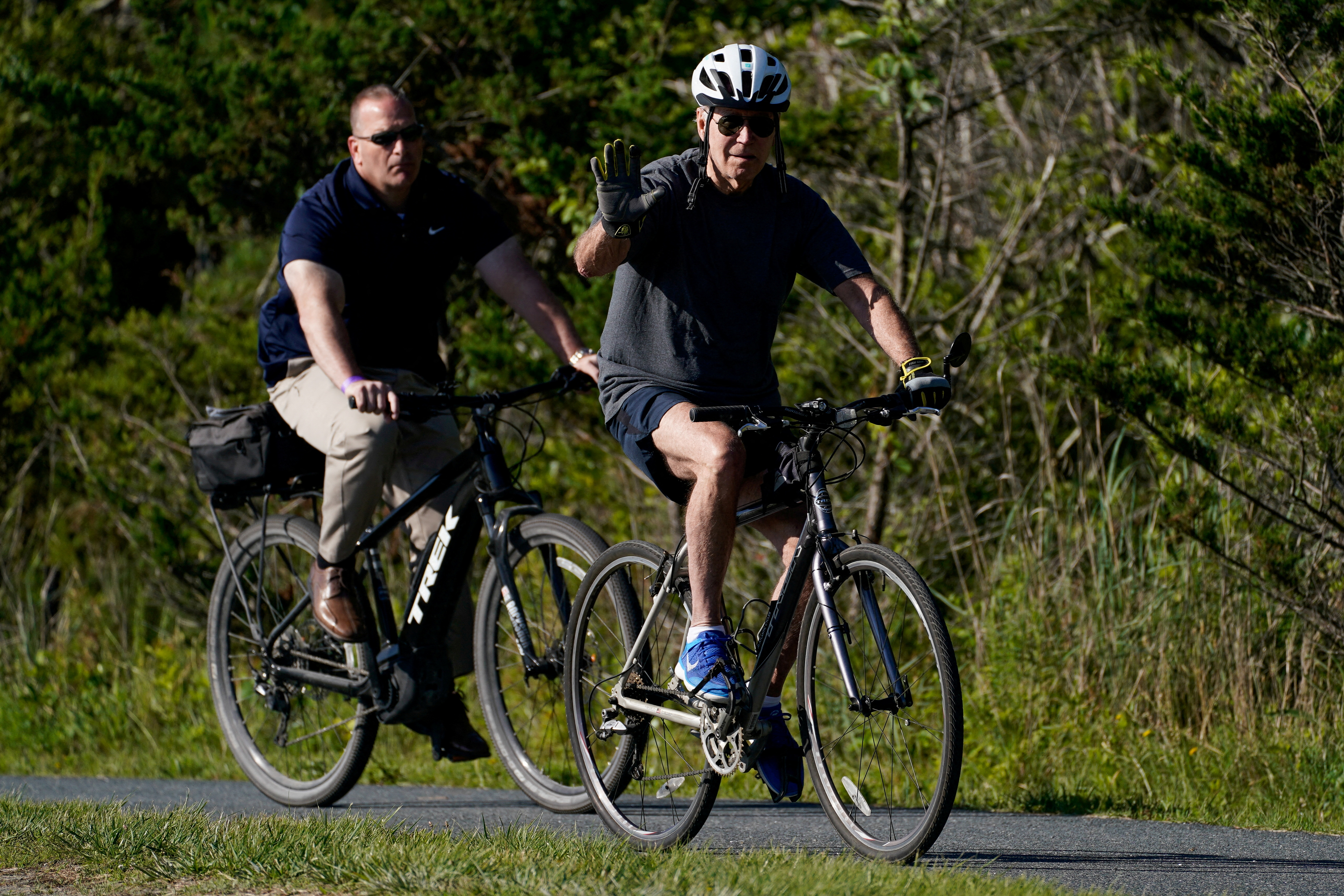 US President Joe Biden rides a bike in Rehoboth Beach, Delaware.