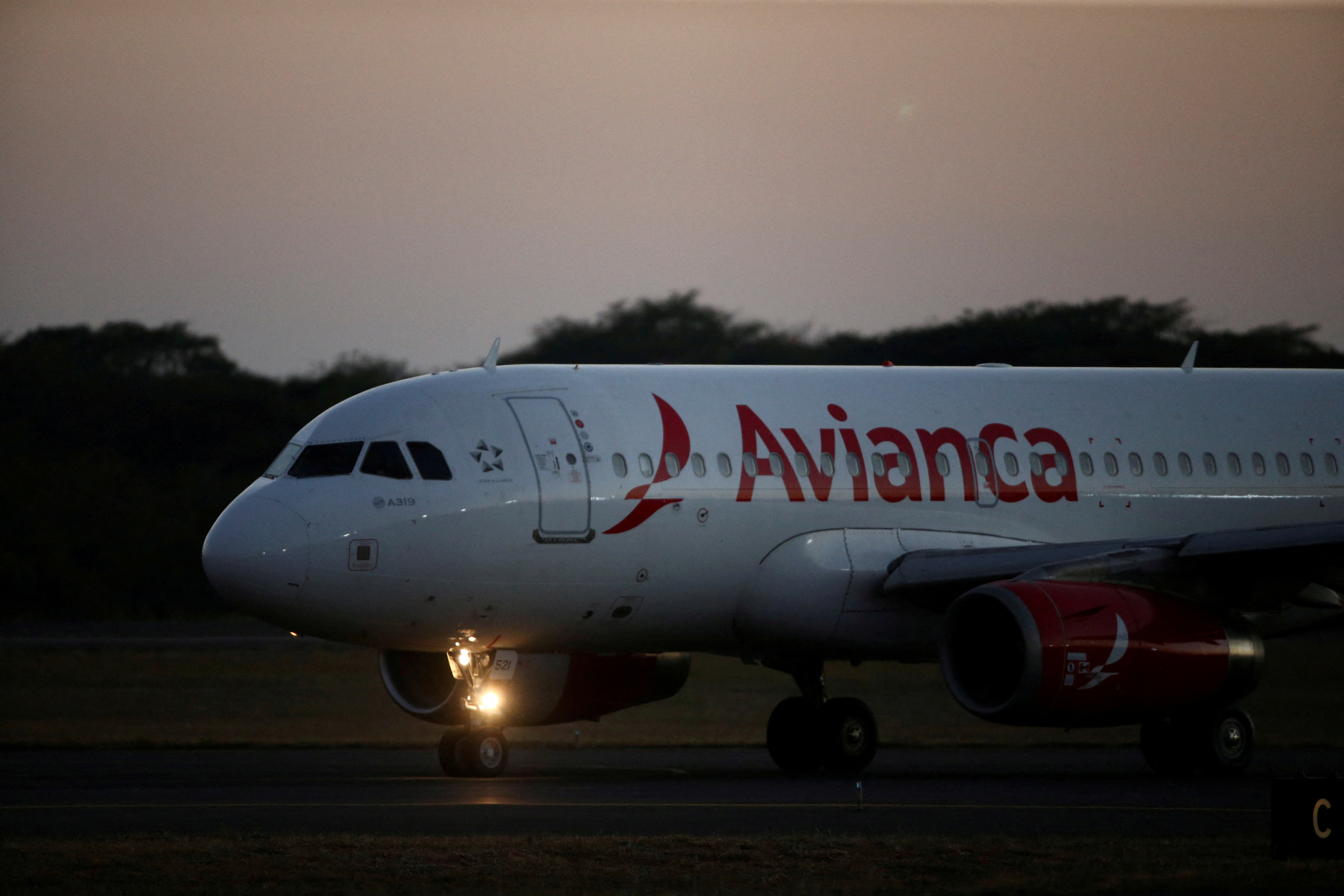 An Avianca Airlines plane prepares to take off at the San Oscar Arnulfo Romero International Airport in San Luis Talpa