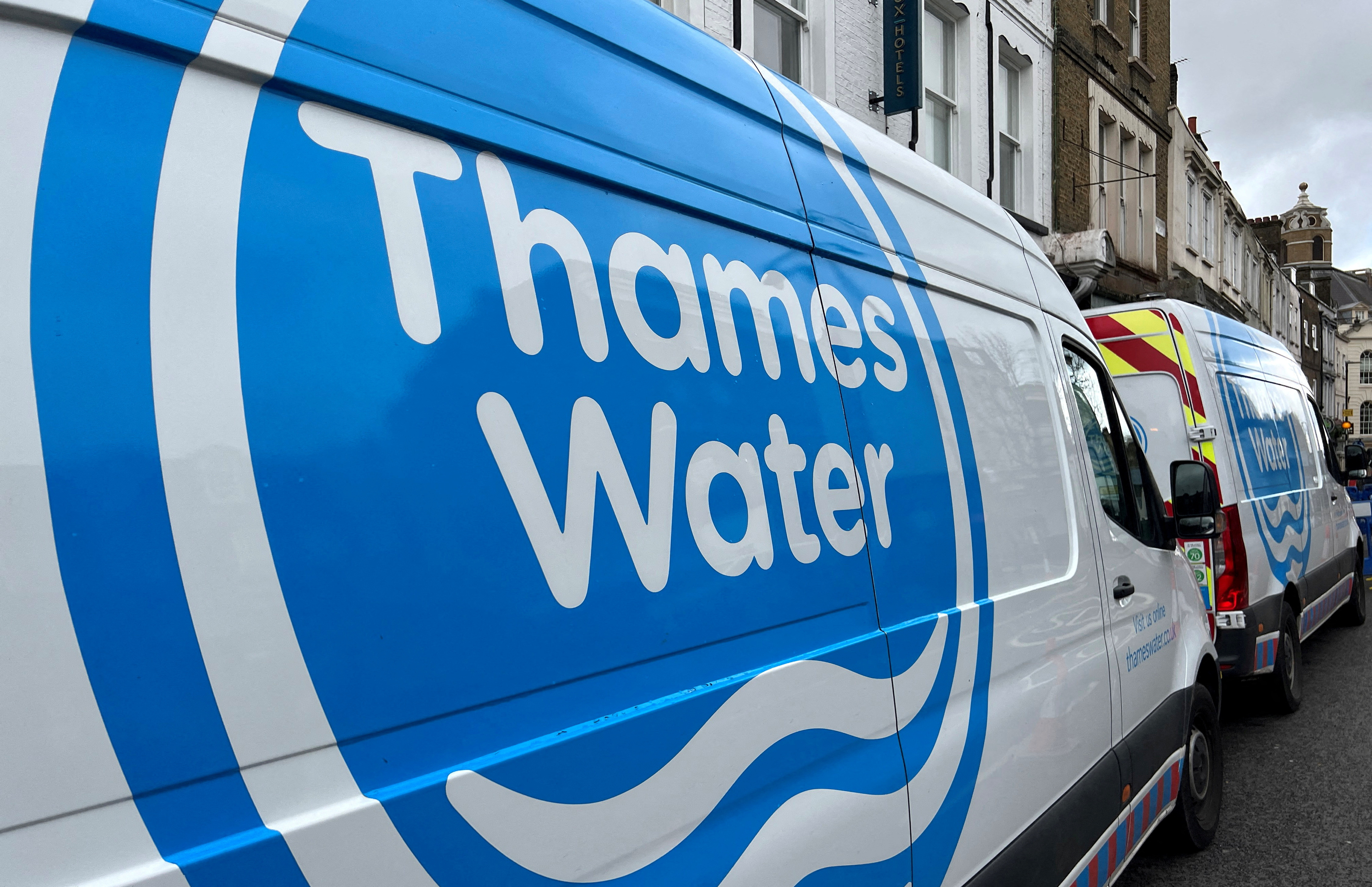 Thames Water vans are parked as repair and maintenance work takes place, in London