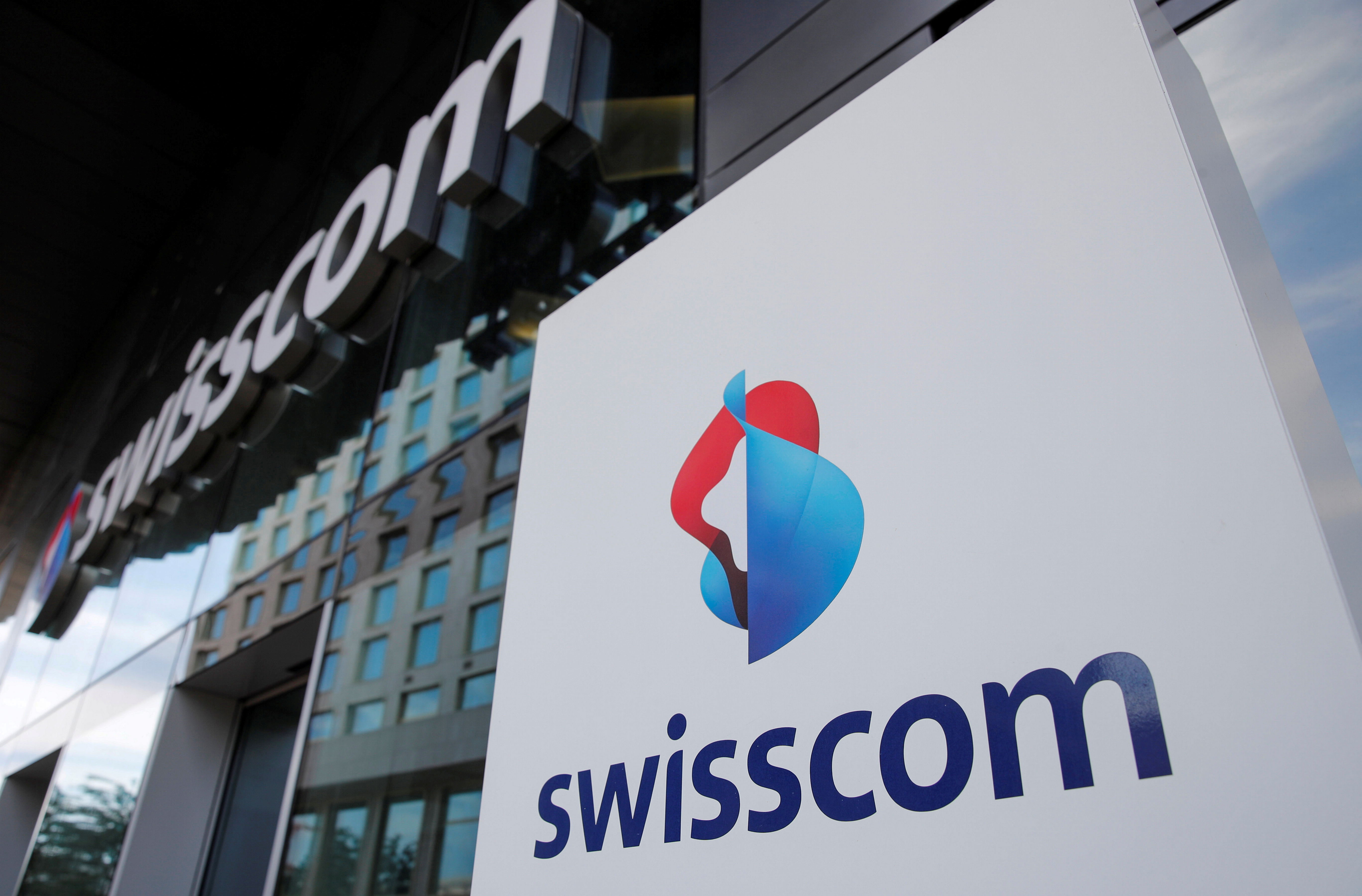 The logo of Swiss telecoms group Swisscom is seen at an office building, in Zurich