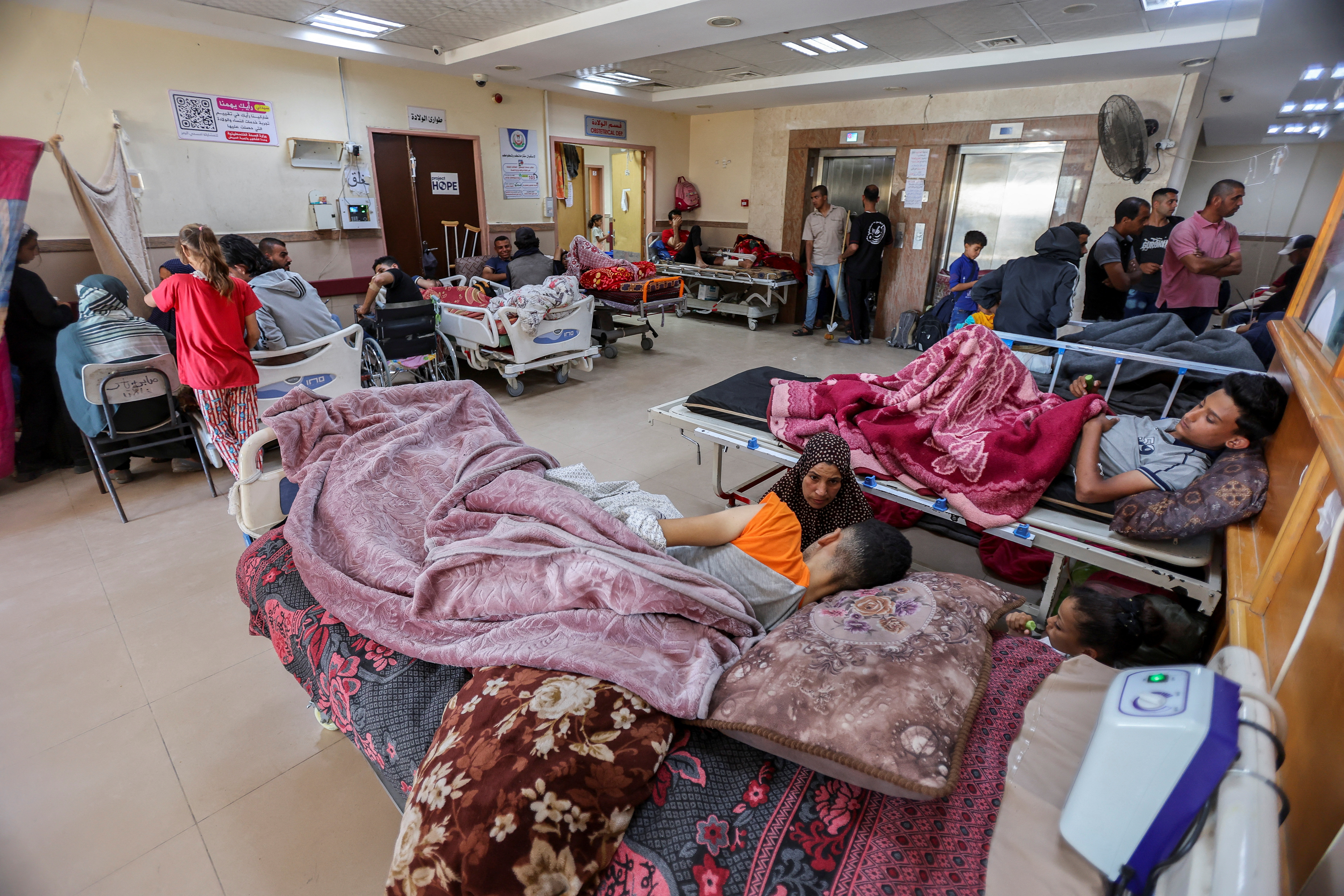 Palestinians wounded in Israeli fire lie on beds as they receive treatment at Al-Aqsa hospital in Deir Al-Balah in the central Gaza Strip