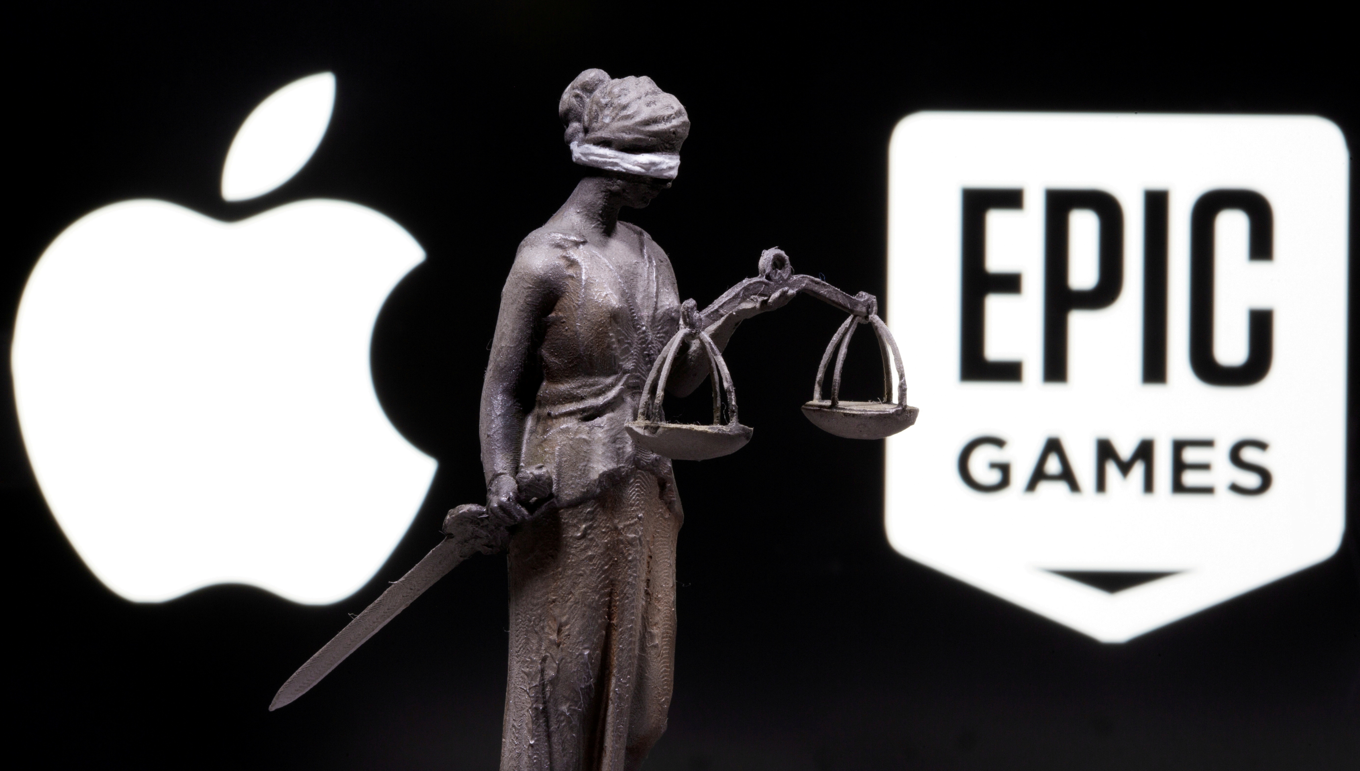 3D printed Lady Justice figure is seen in front of displayed Apple and Epic Games logos in this illustration photo taken February 17, 2021. REUTERS/Dado Ruvic/Illustration/File Photo